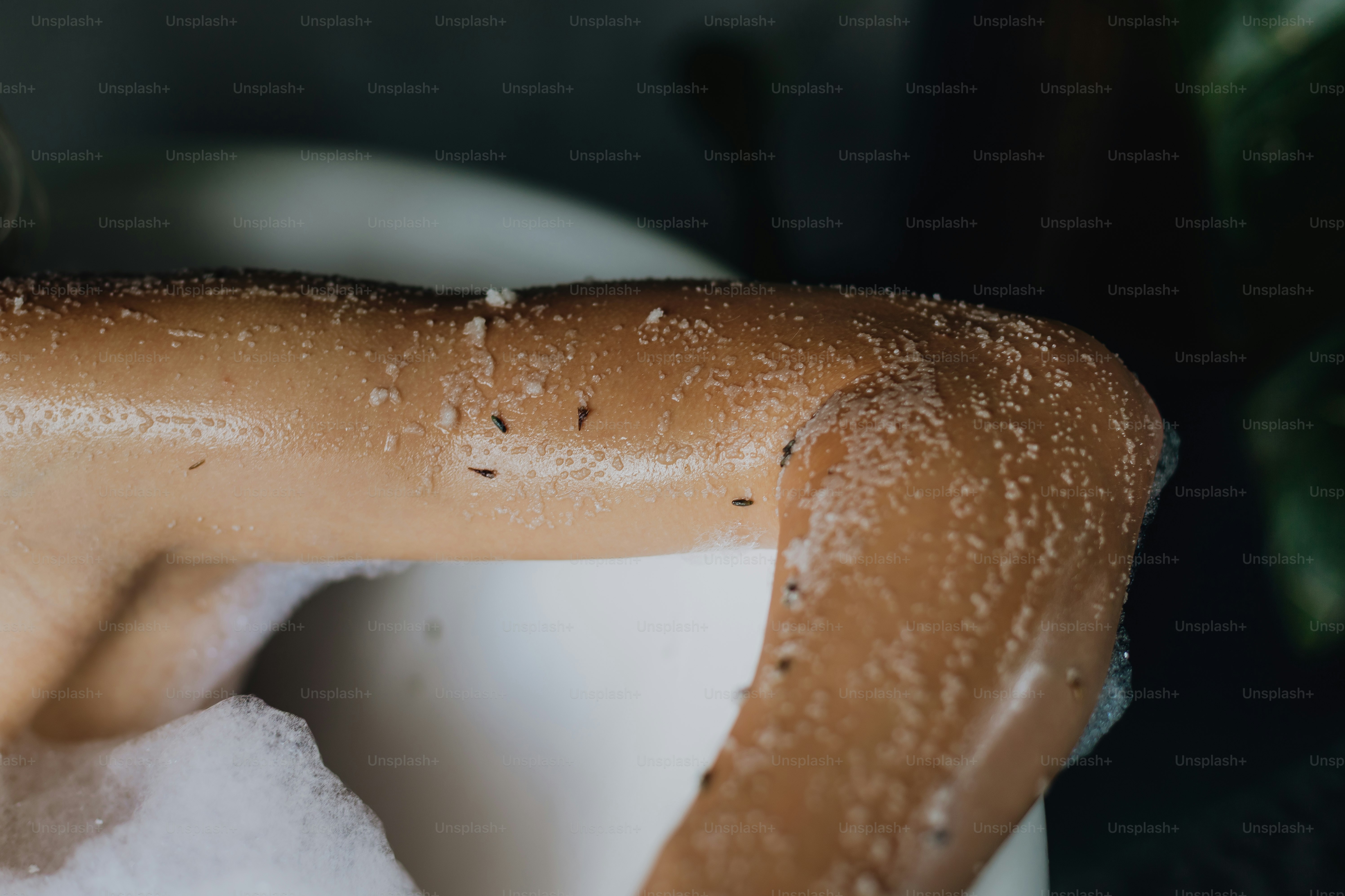 Close-up of a person's arm with water droplets.