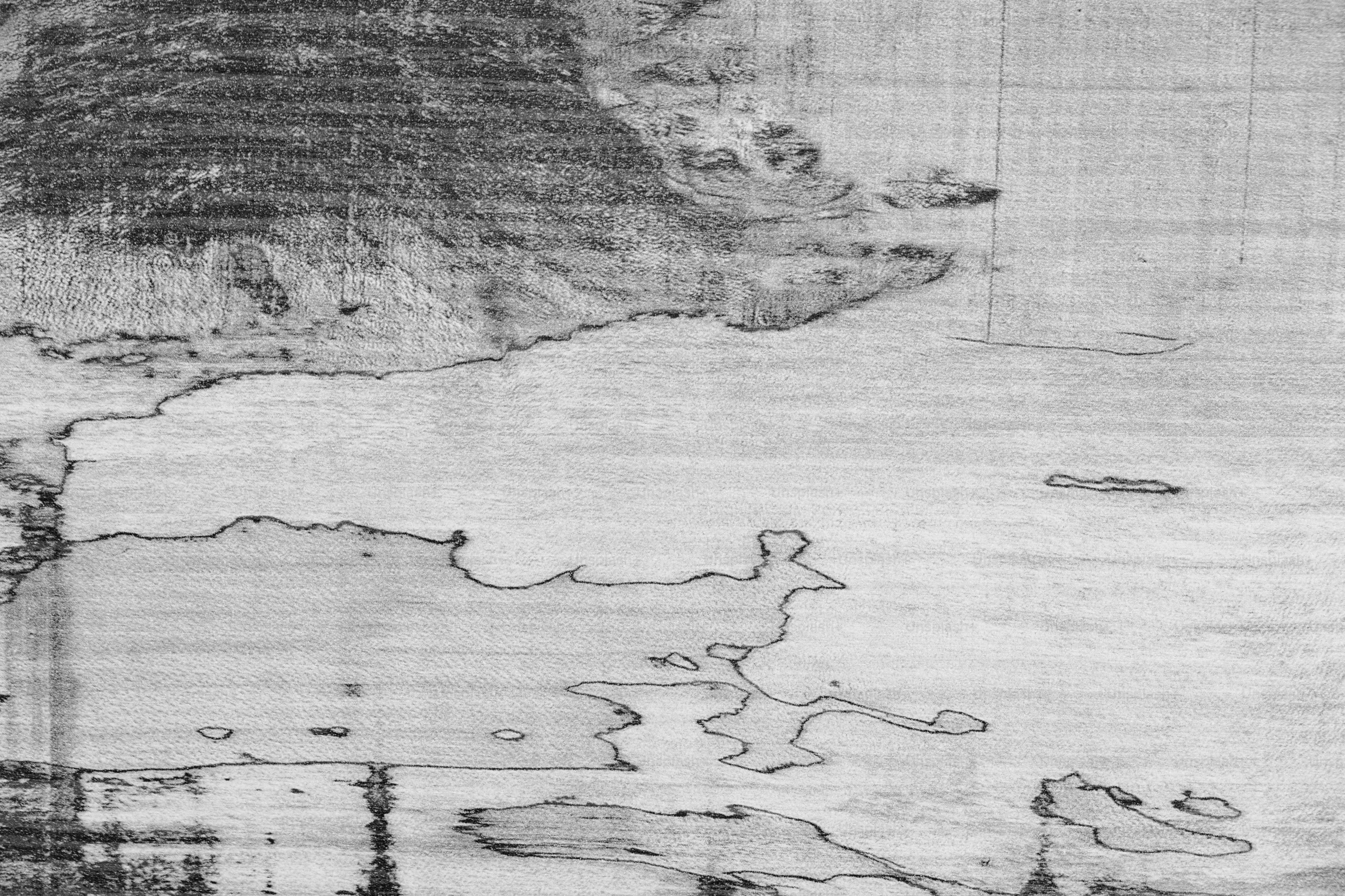 An old parchment map spread across a wooden desk, ink-stained hands tracing the edge of an uncharted coastline beneath candlelight.