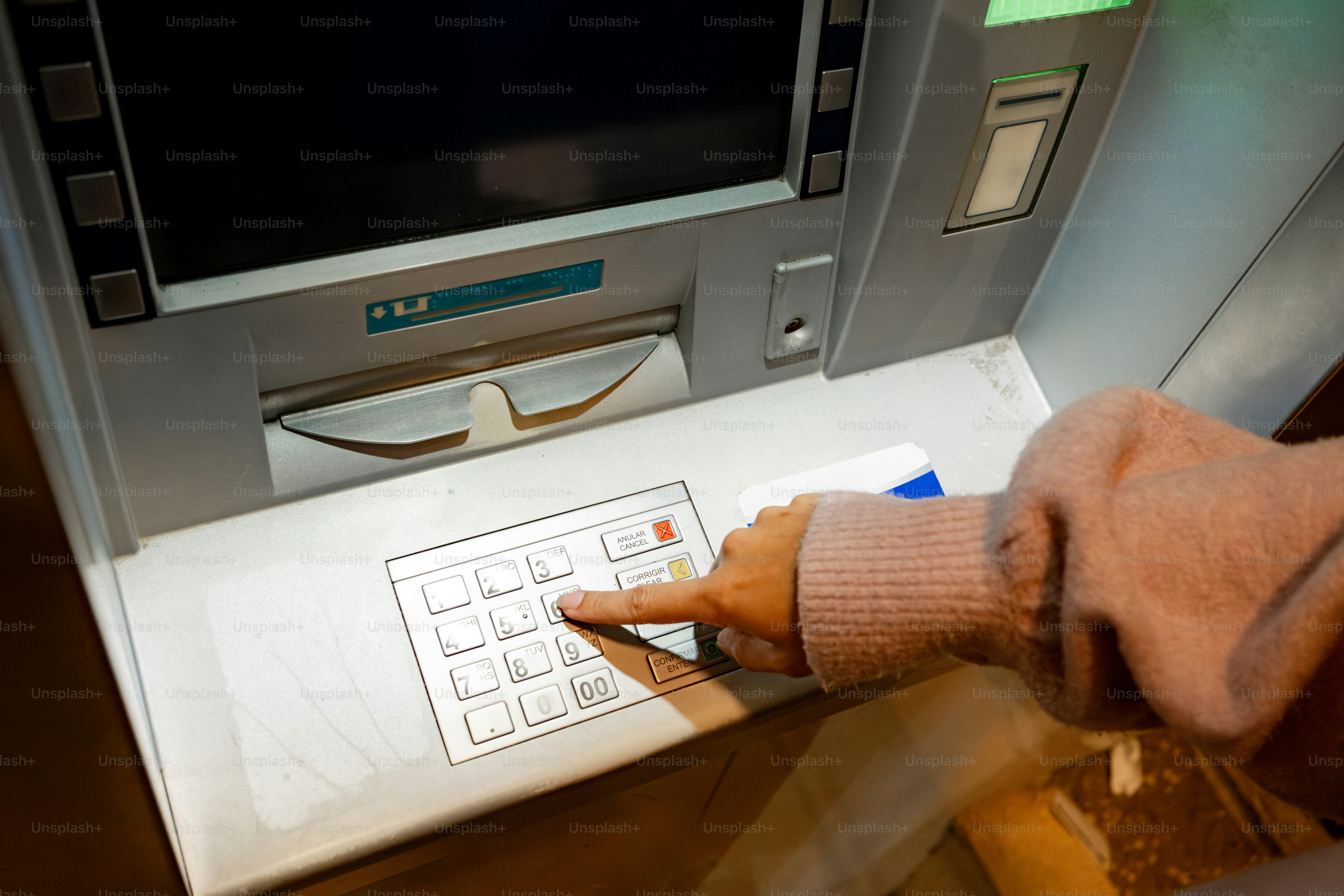 Person's hand using an atm keypad to withdraw money photo – Money Image ...