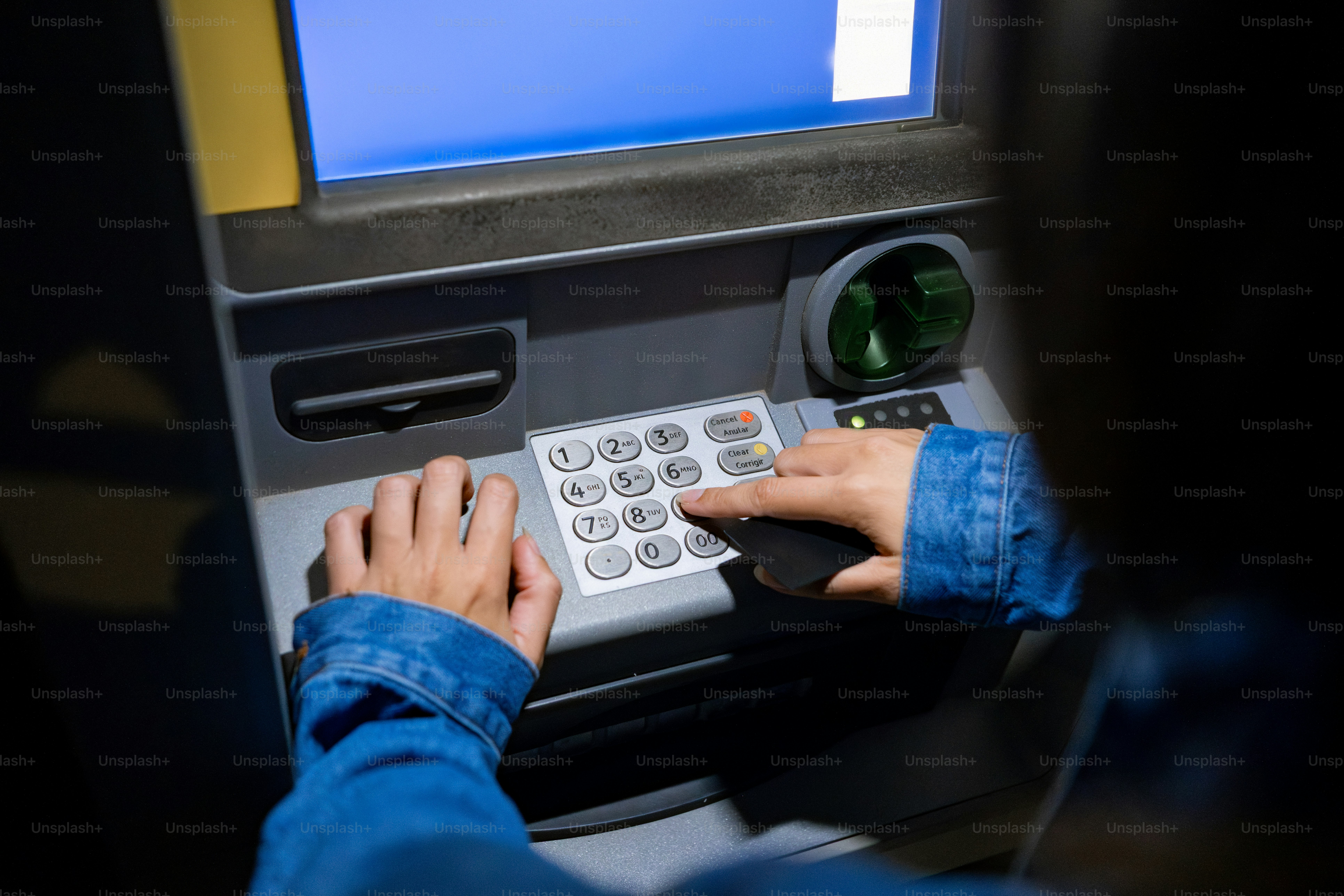 Person using a keypad on an atm machine. photo – Money Image on Unsplash