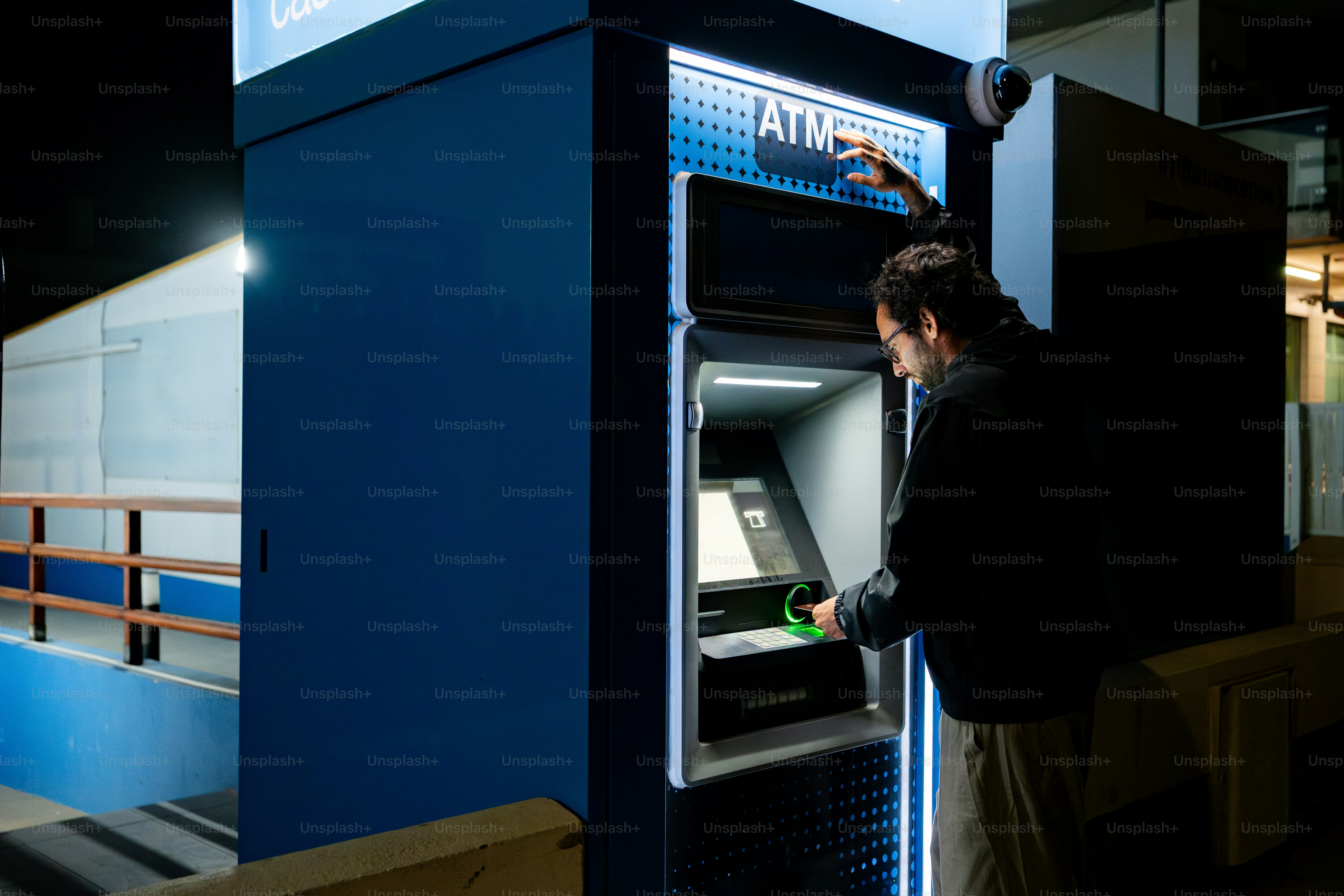 Person using atm at night photo – Money Image on Unsplash