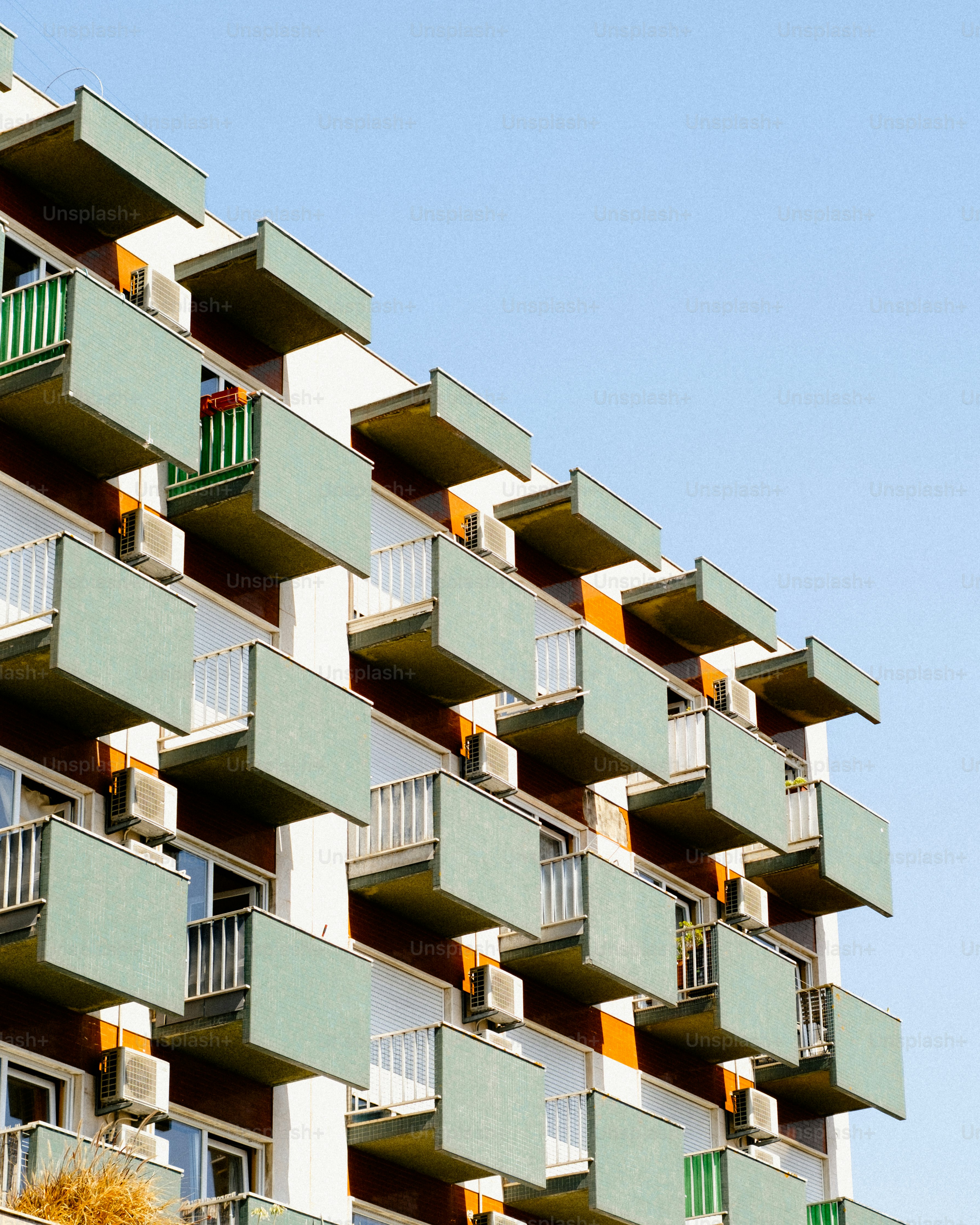 Modern apartment building with balconies against blue sky
