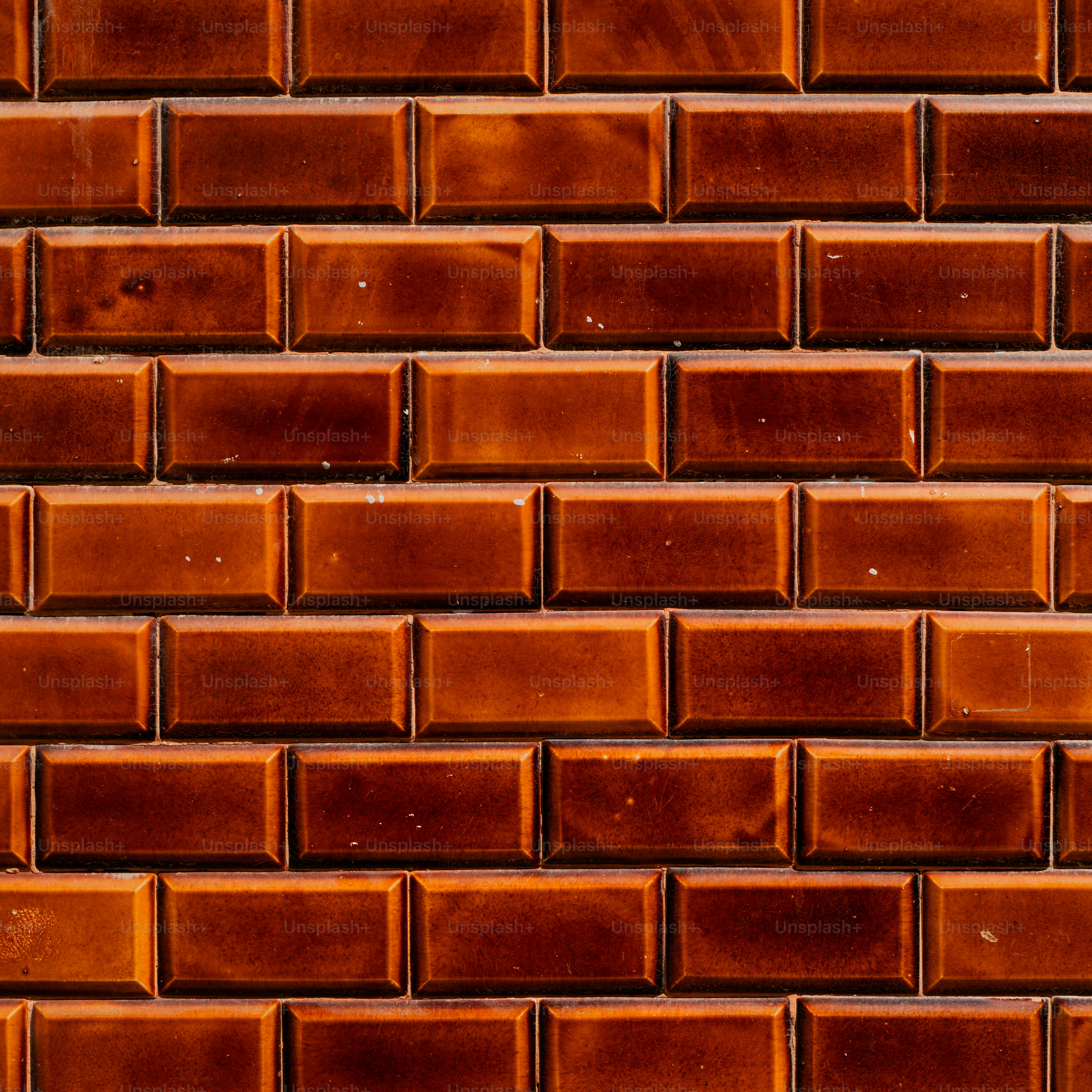 A textured brick wall with warm brown tones