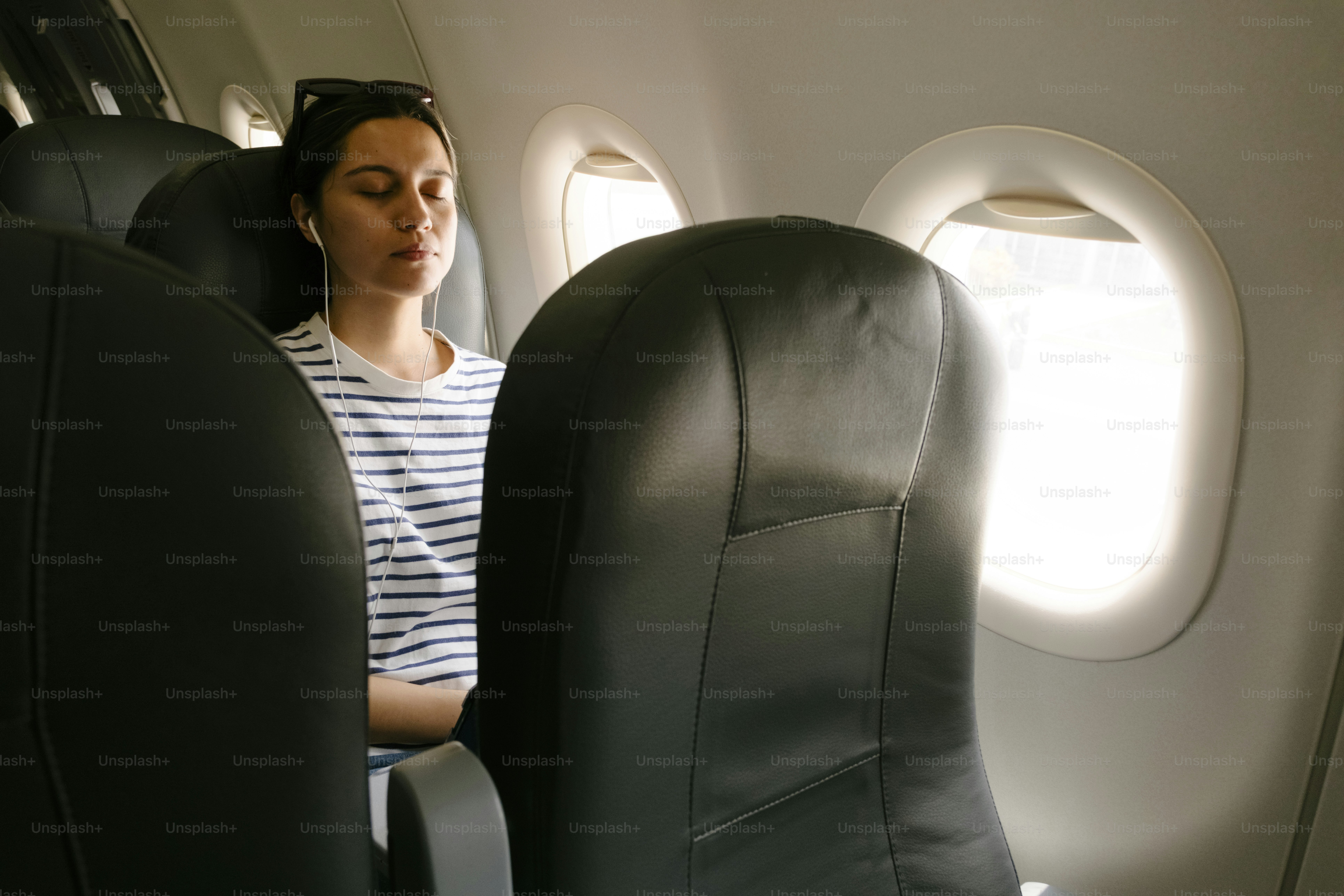 Woman standing inside an airplane cabin