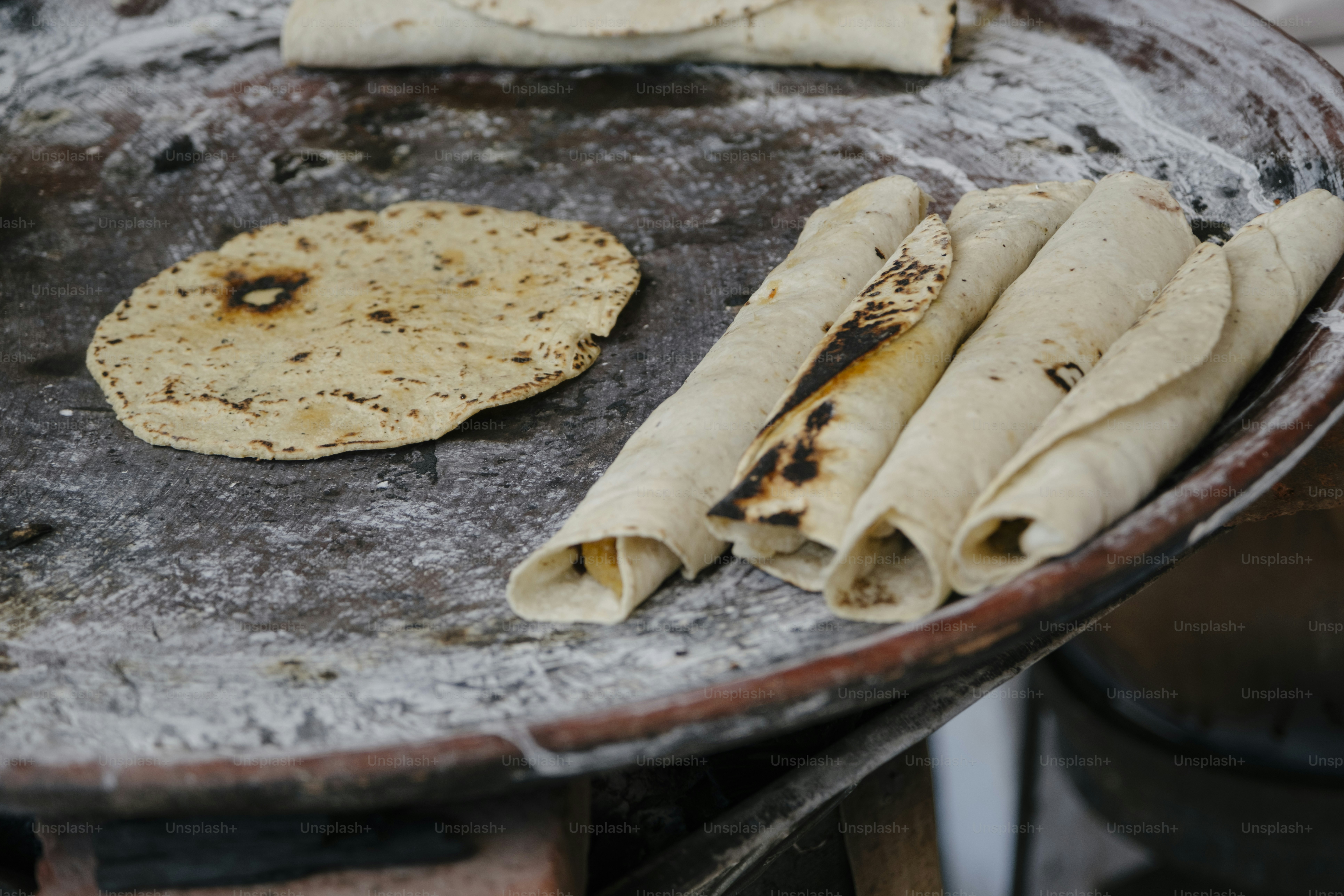 Flatbreads cooking on a hot comal.