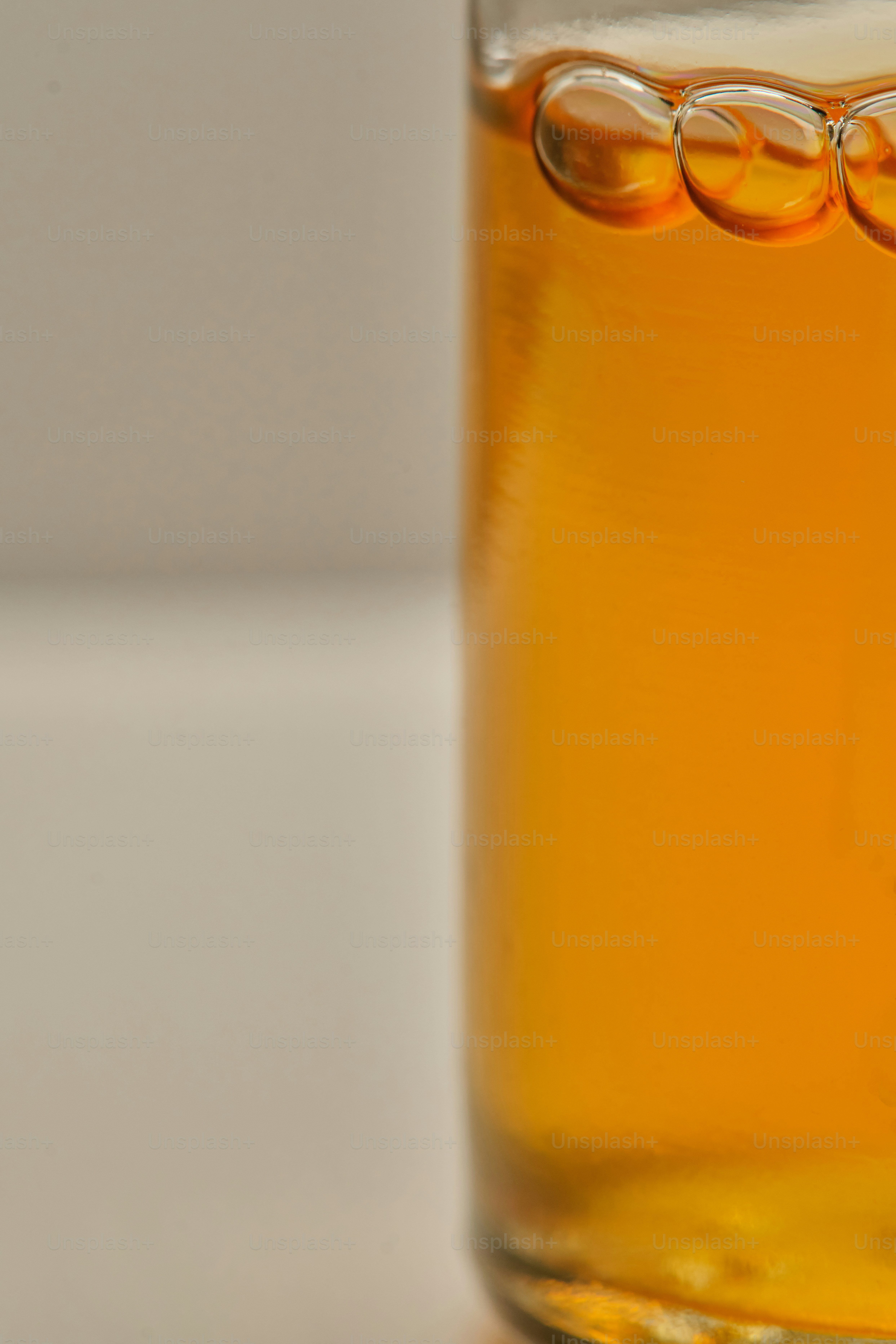 Close-up of amber liquid with bubbles in a glass