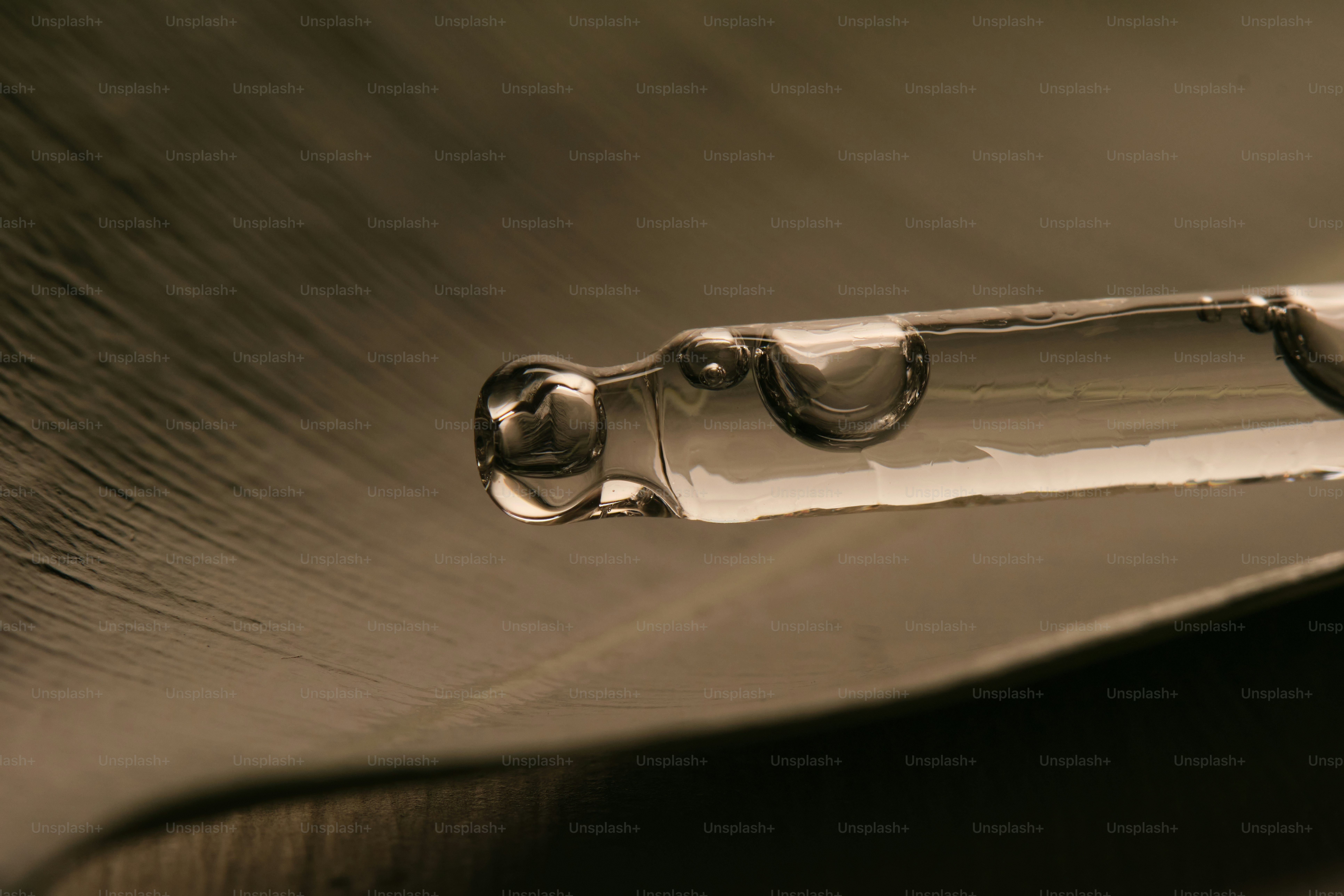 Close-up of a dropper tip with a drop of liquid. photo – Background ...