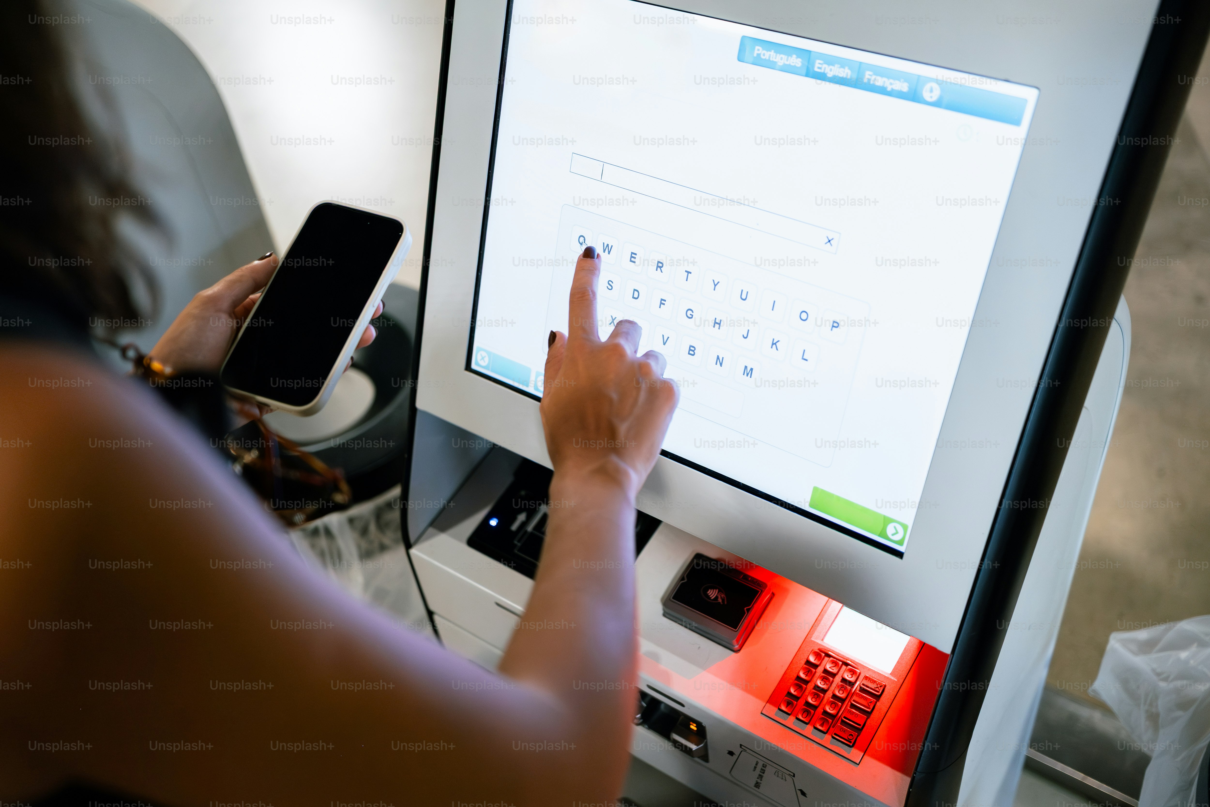 Person using a touchscreen kiosk with a smartphone. photo – Travel ...