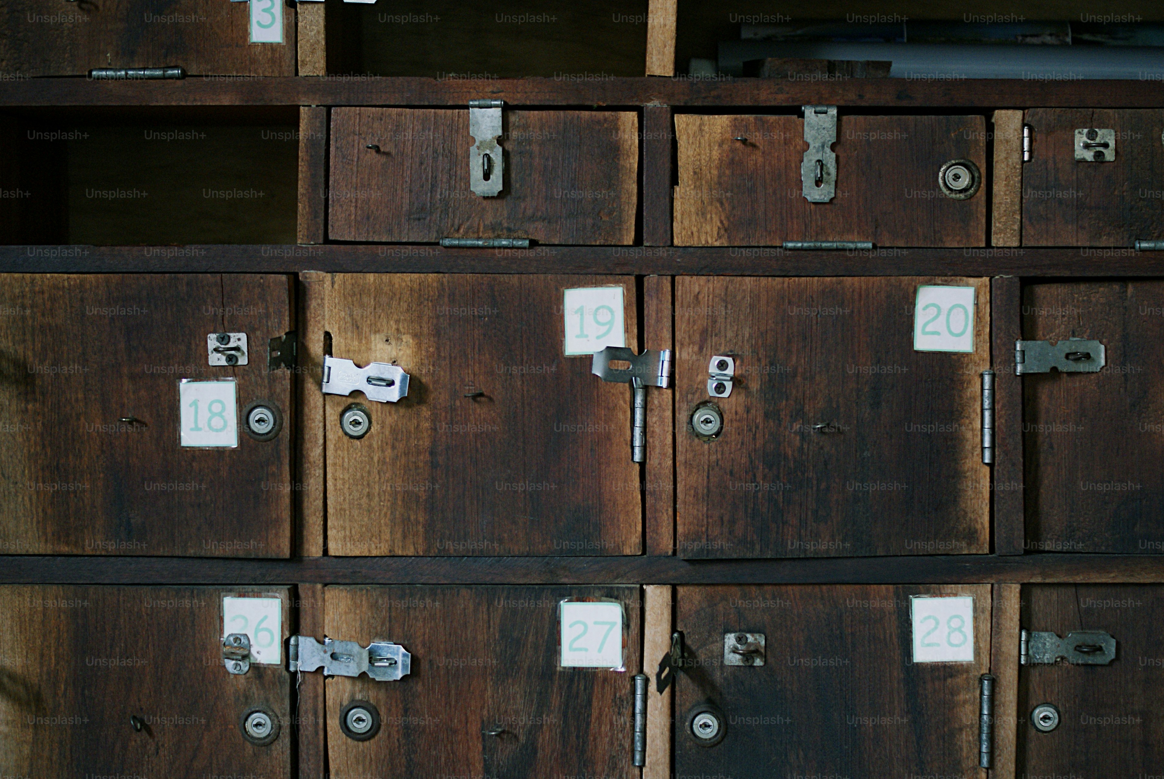 Rows of old wooden lockers with numbers