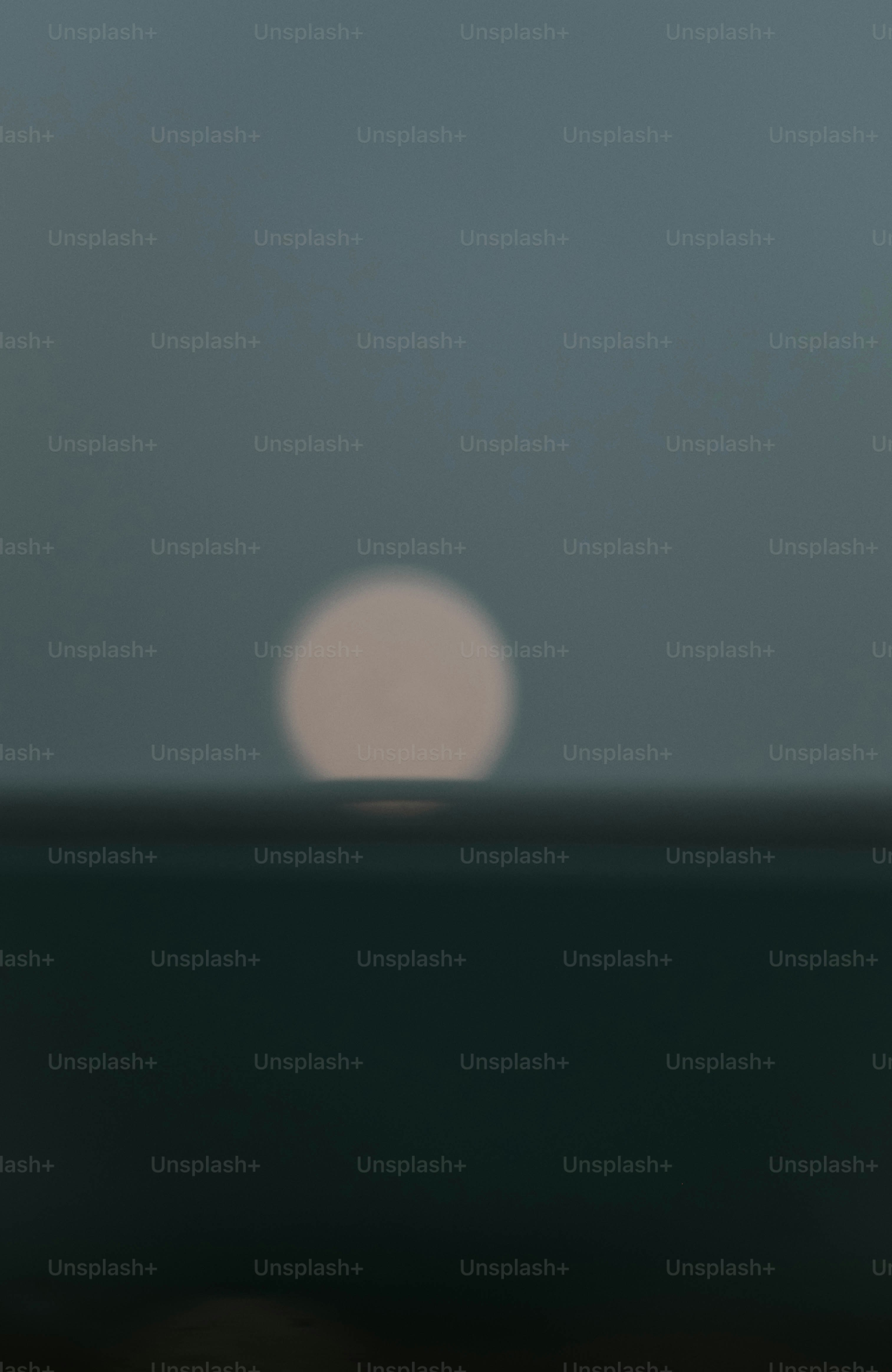 Sun setting over the calm ocean horizon