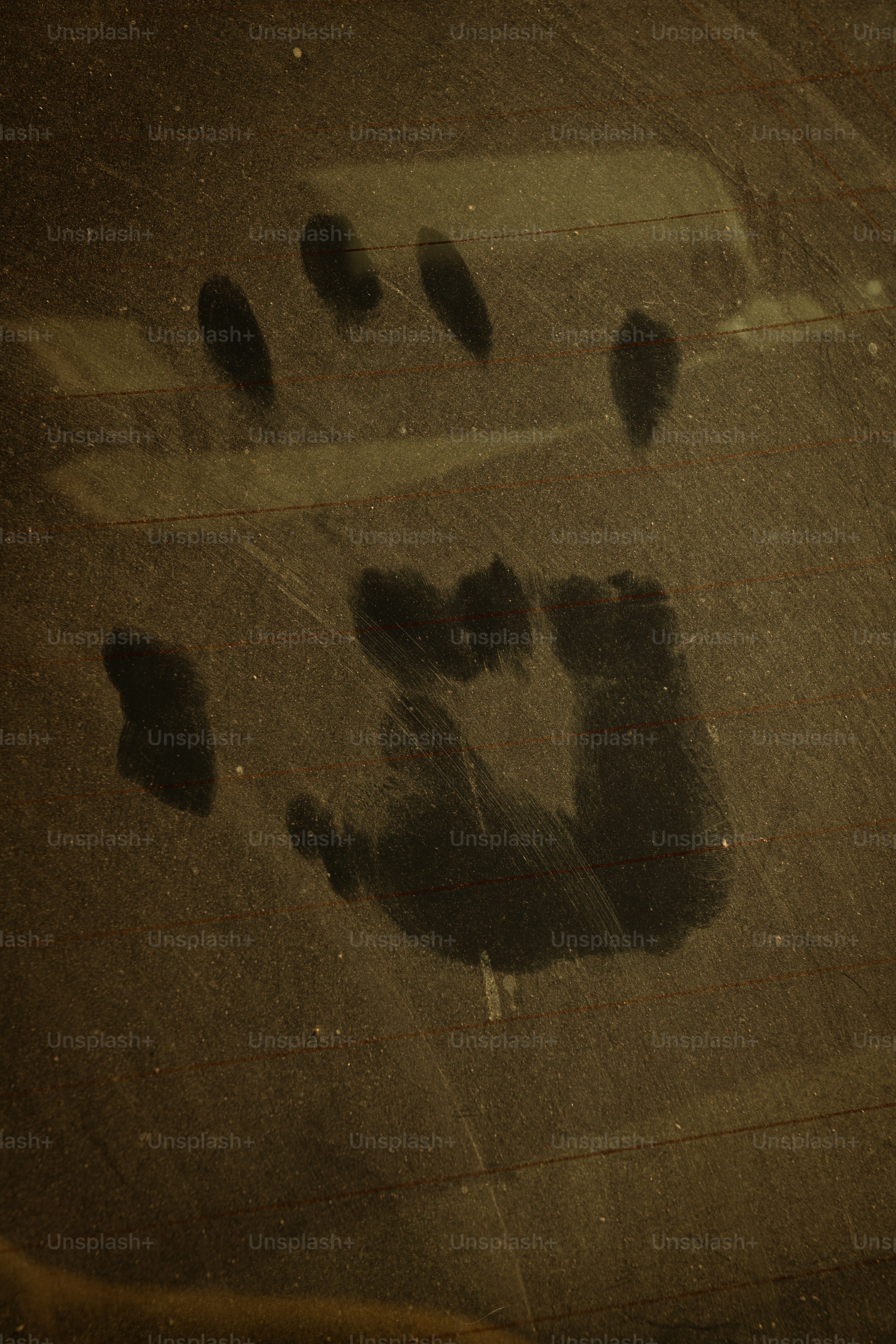 A dusty handprint on a dirty surface