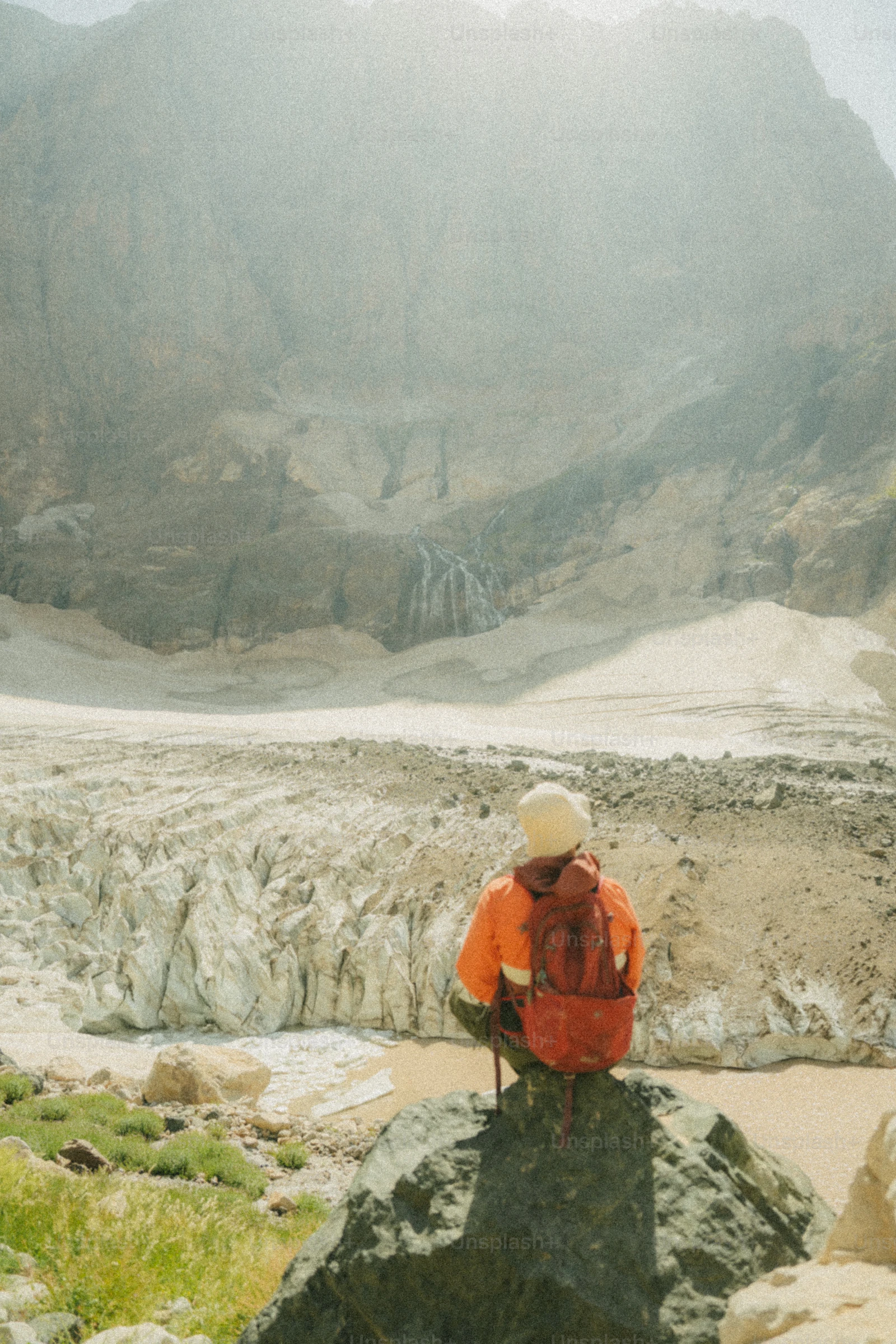 Digital nomad enjoying remote work in nature, dressed casually with a backpack