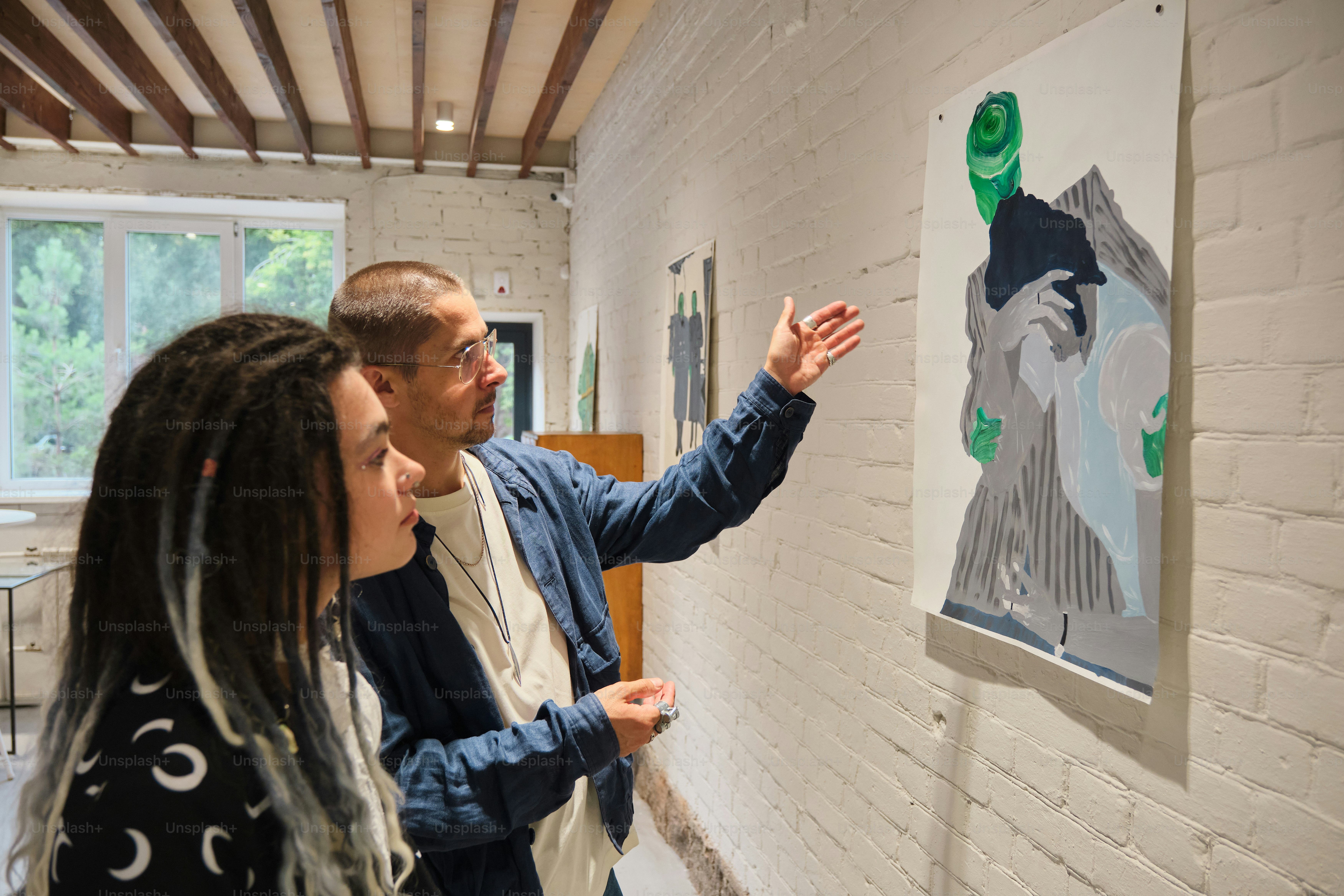 Man observing artwork in a modern gallery photo – Art Image on Unsplash