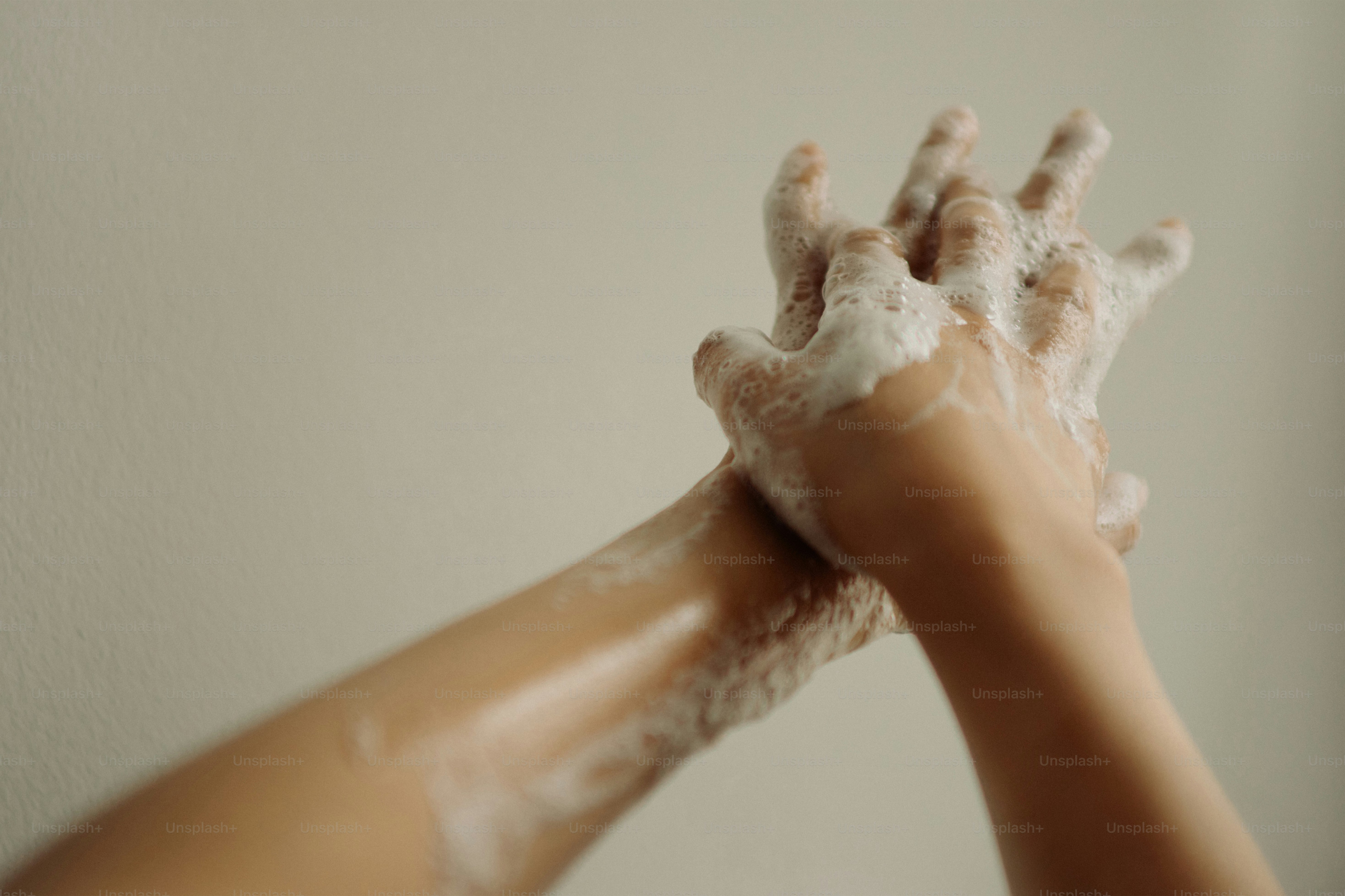 Person washing hands with soap and water