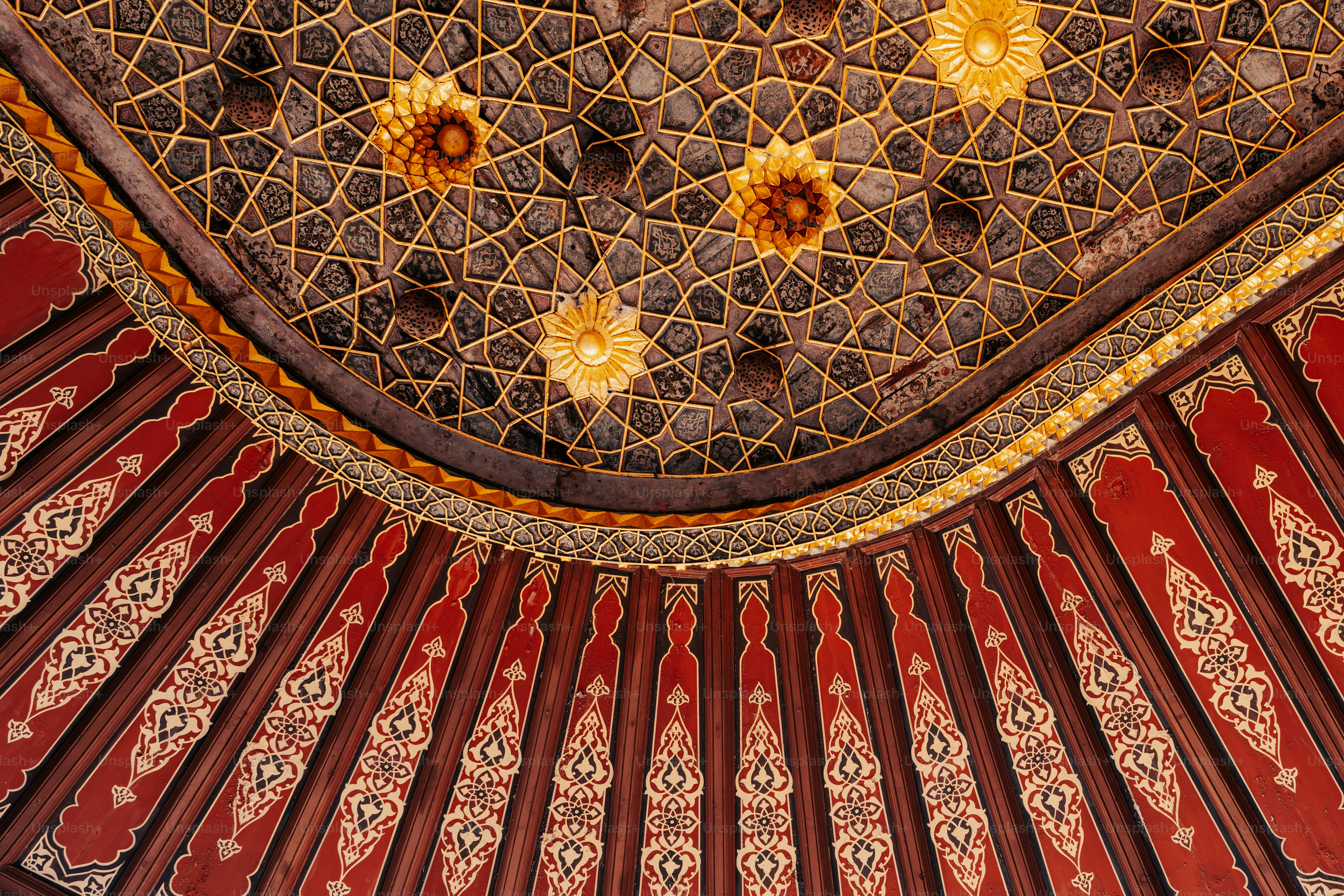Intricate geometric ceiling with red and gold details