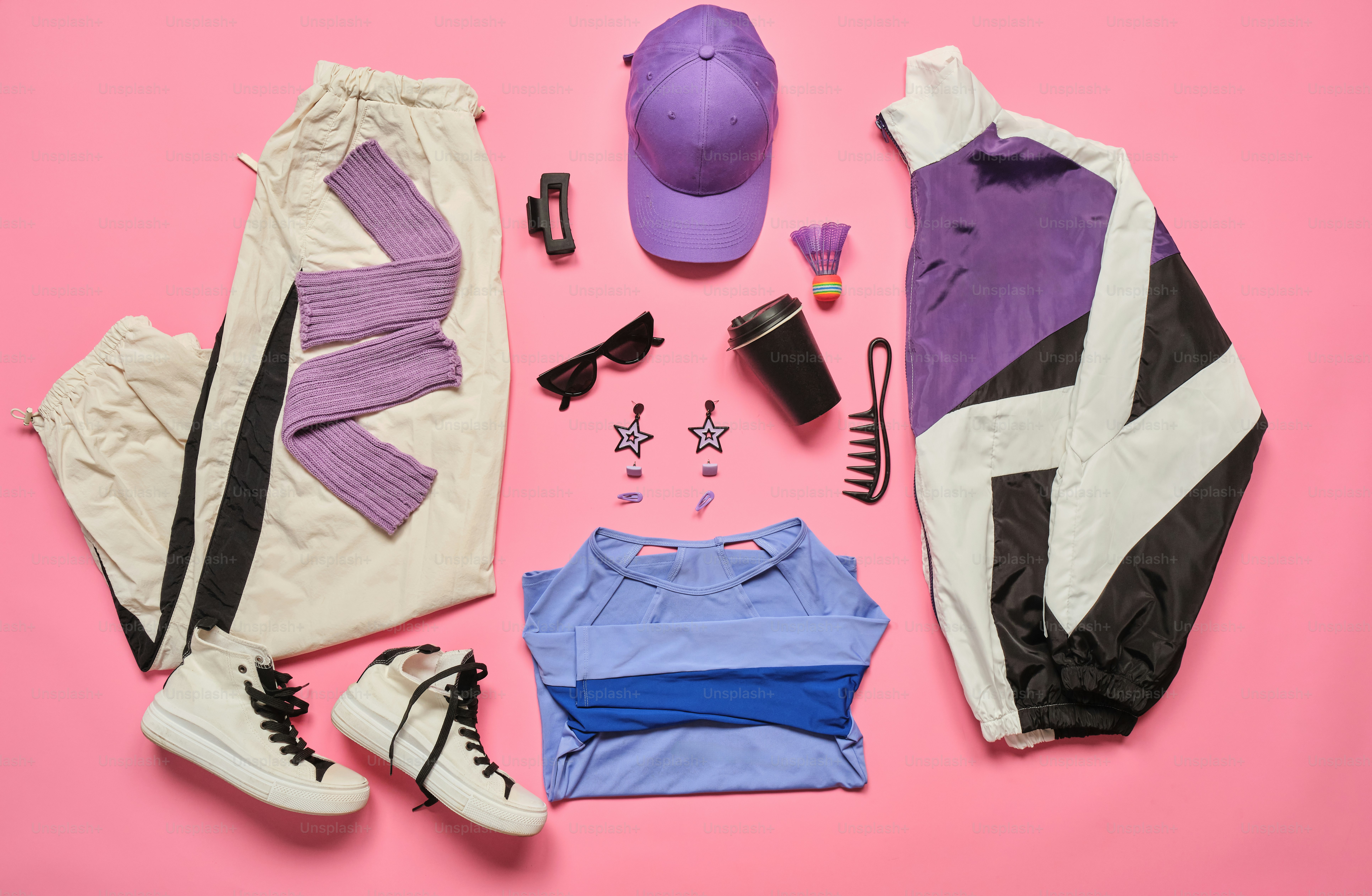 Athletic apparel and accessories arranged on pink background