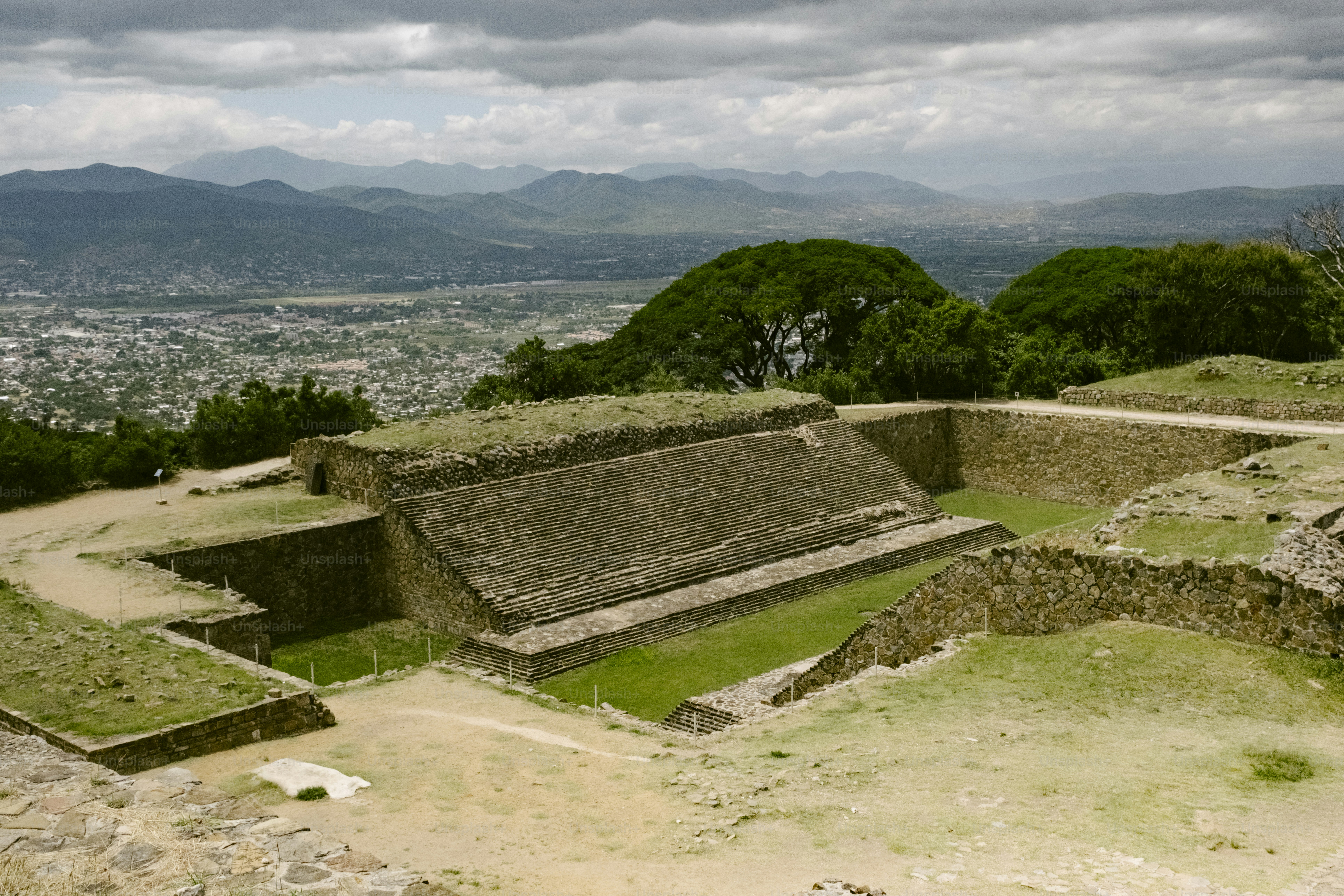 Ancient stone ruins overlooking a valley and city