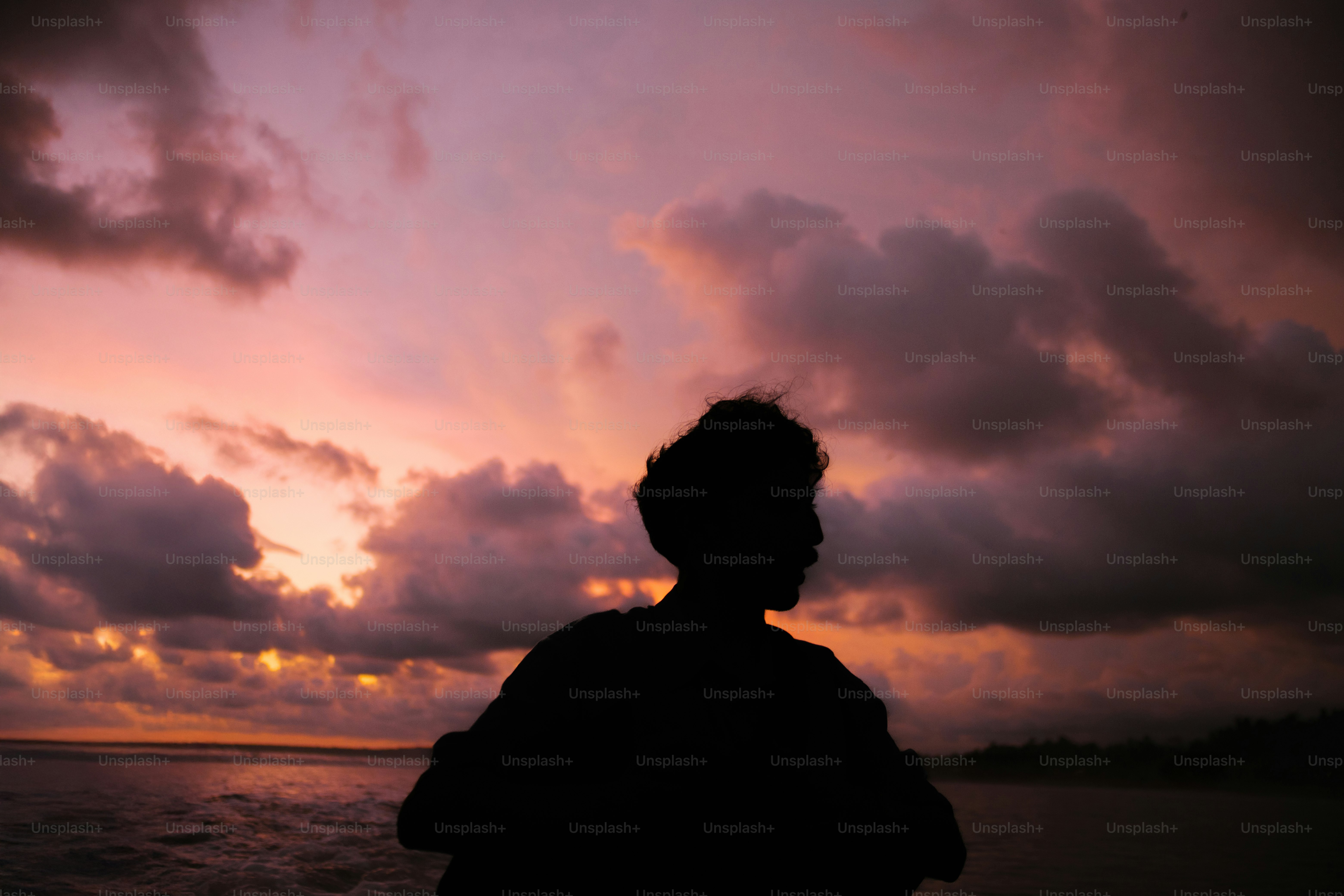 A young explorer standing at the edge of a floating island, wind in his hair, looking out over an endless sea of clouds pierced by sunlight.