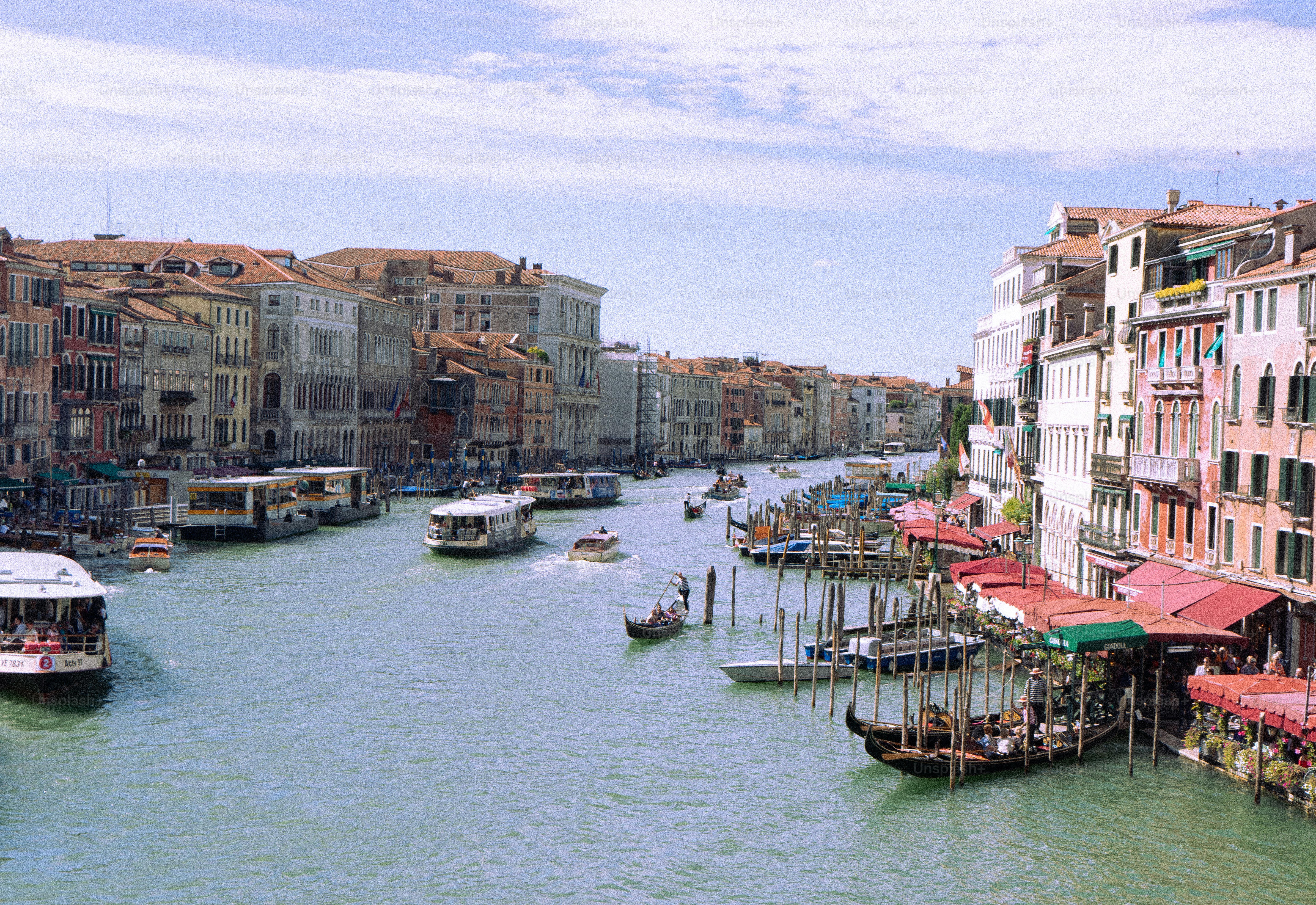 Boats navigate a canal lined with buildings in venice