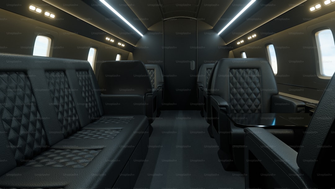 Luxurious private jet interior with dark leather seating.