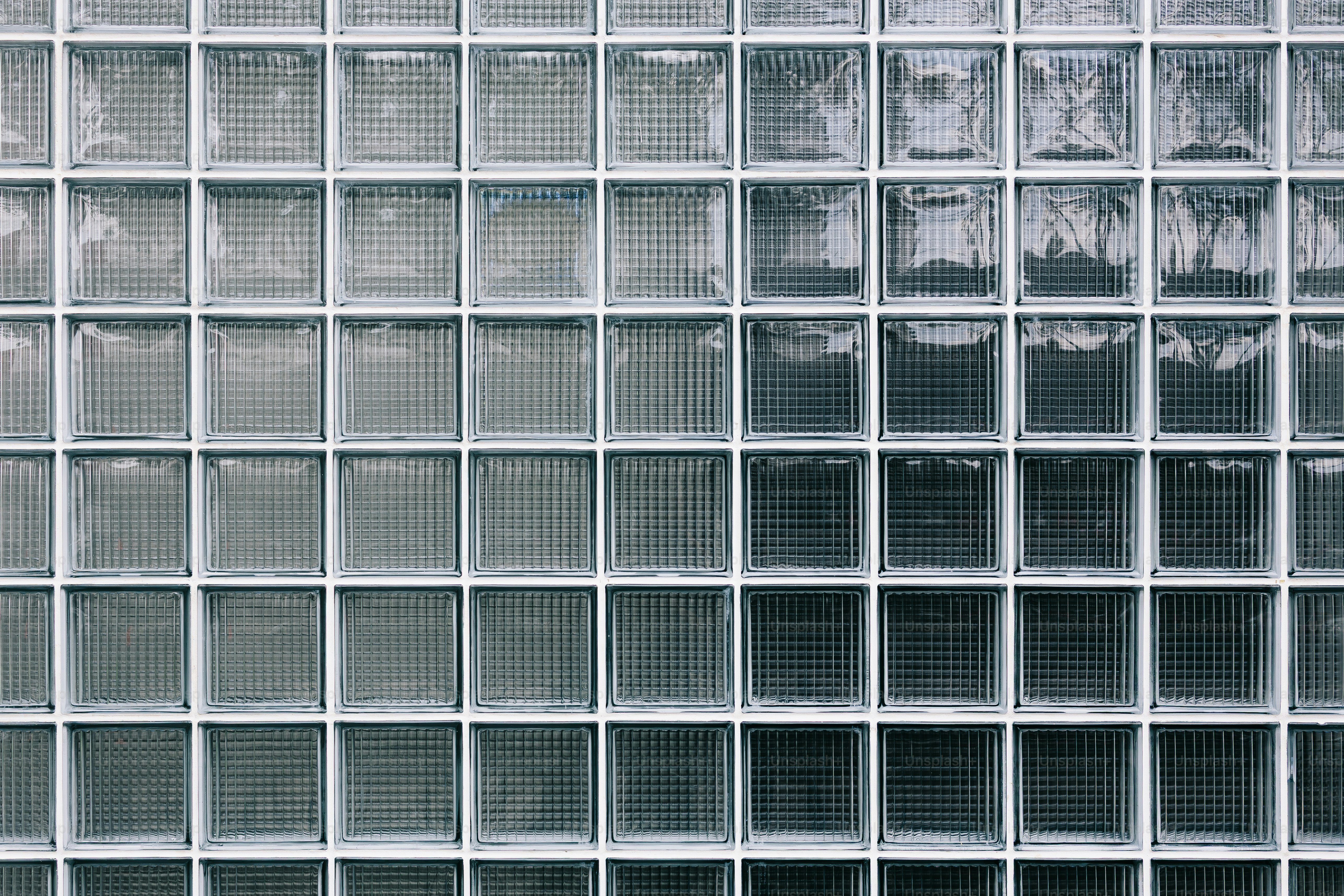 A wall of glass blocks with a textured surface.