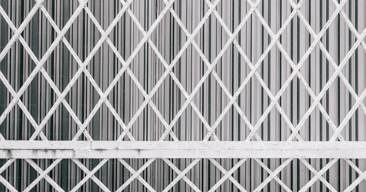 White diamond pattern metal gate against corrugated background photo ...