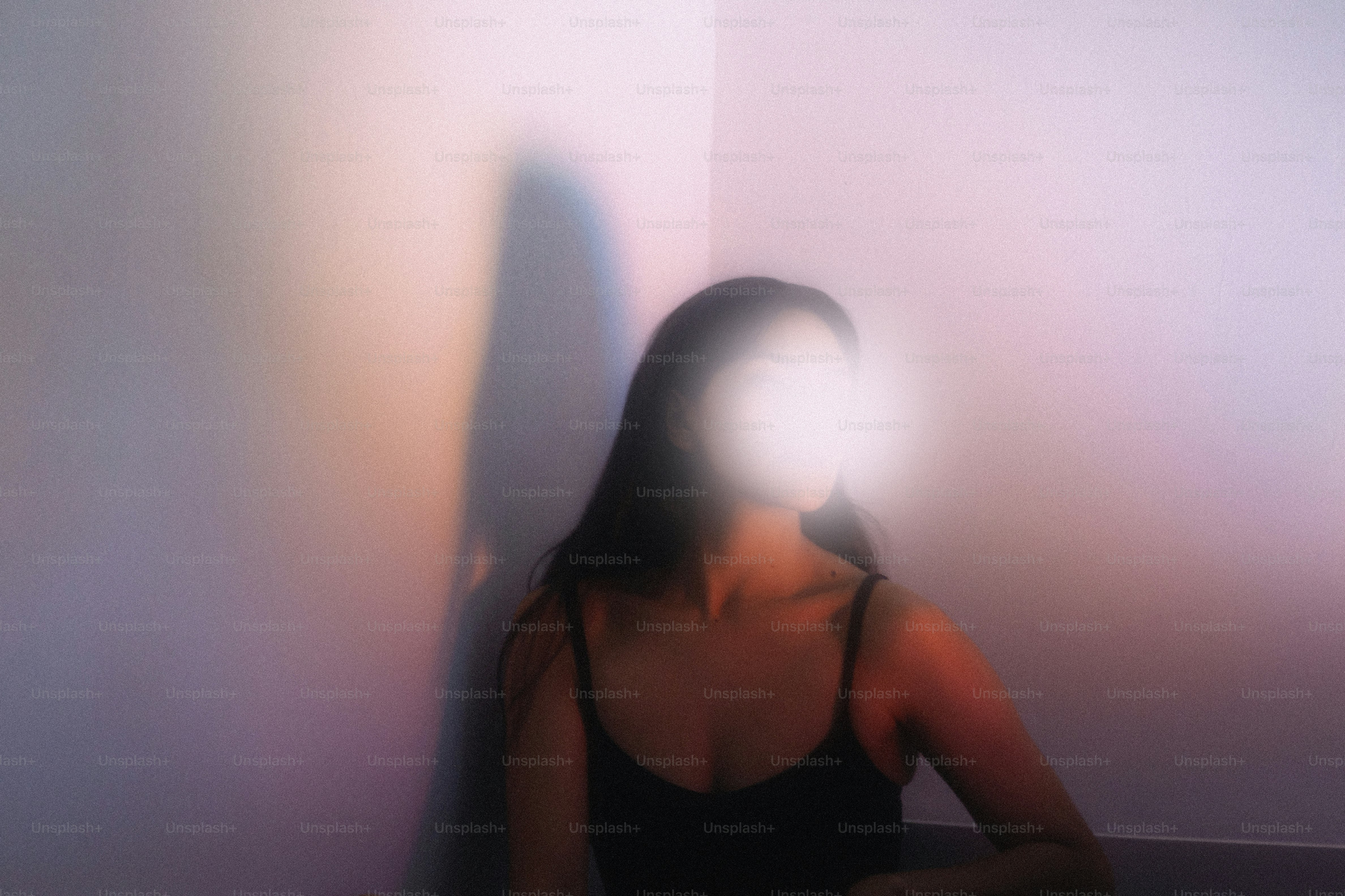 Woman in corner with light obscuring face