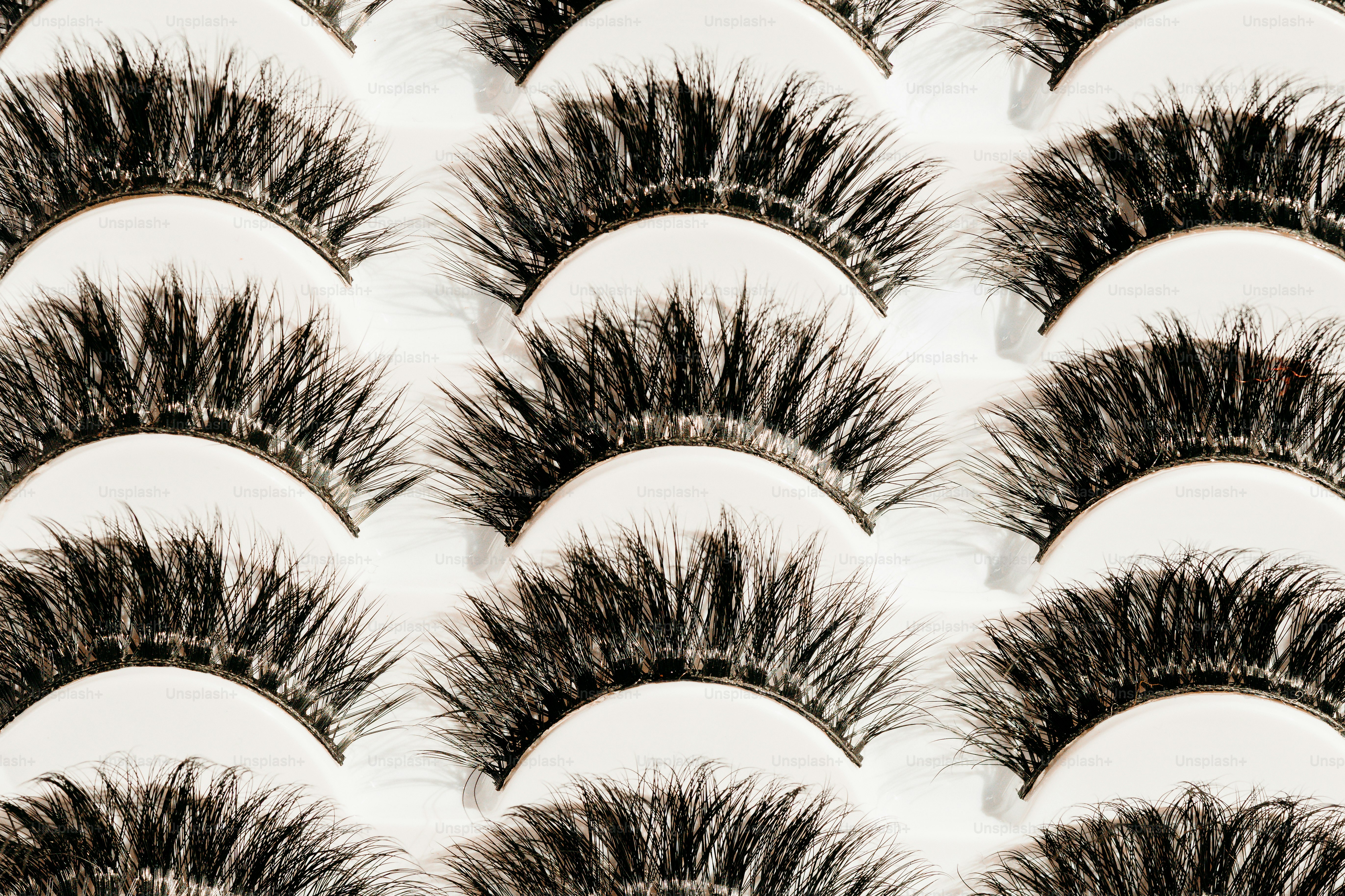 Rows of false eyelashes arranged in a pattern.