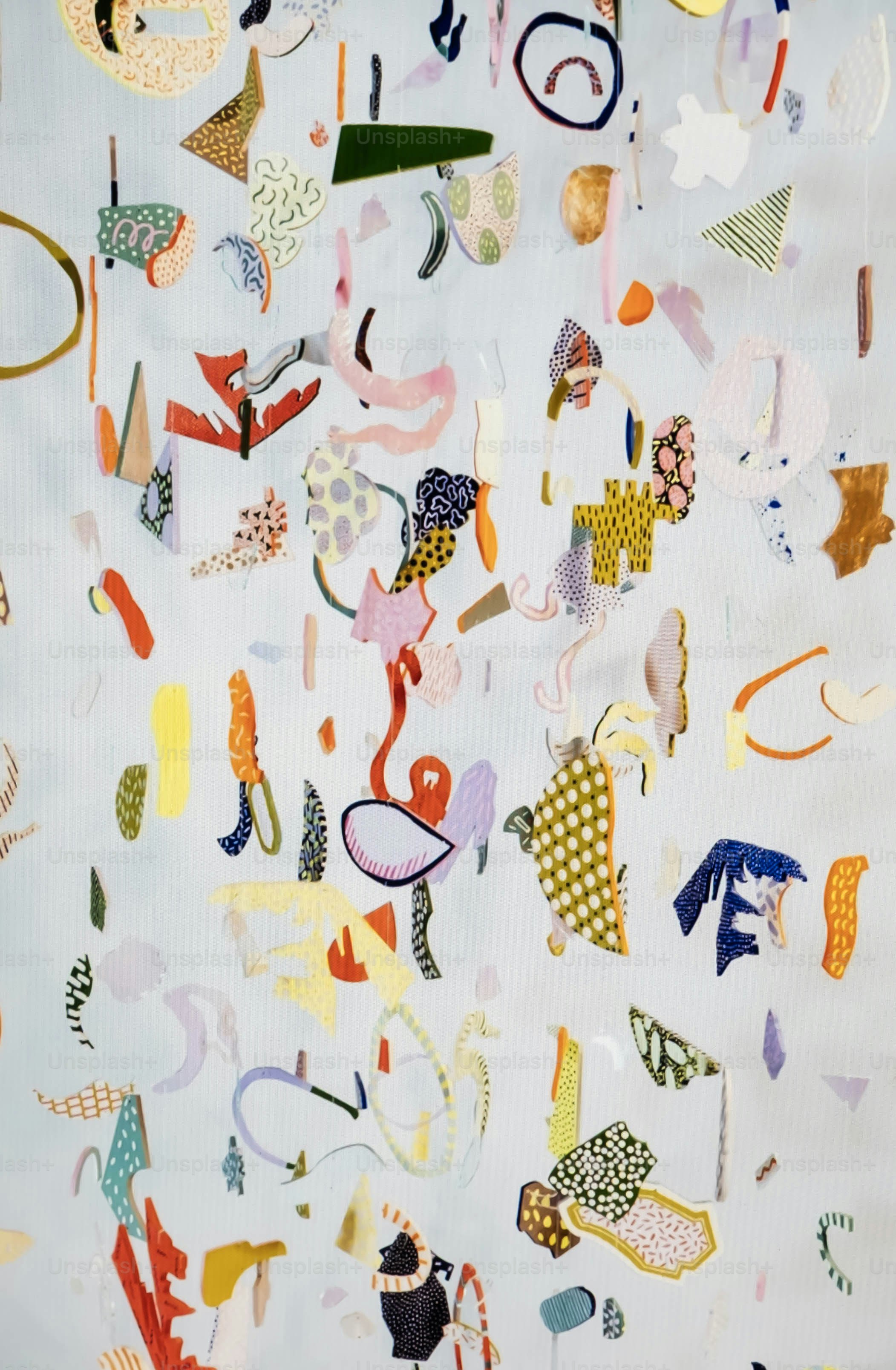 Colorful abstract shapes and patterns floating against a light background