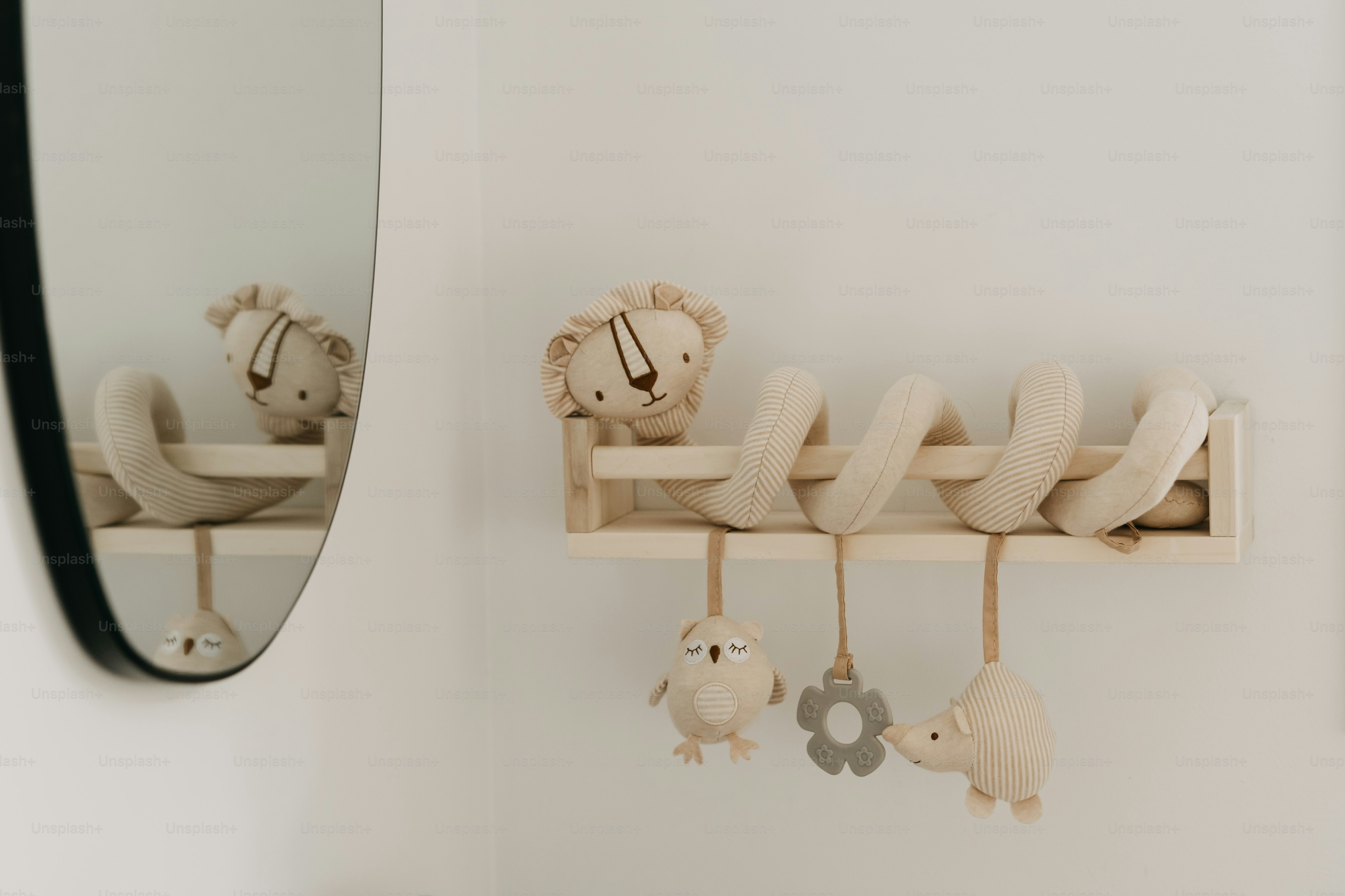 Baby crib toy with lion, bear, and flower decorations