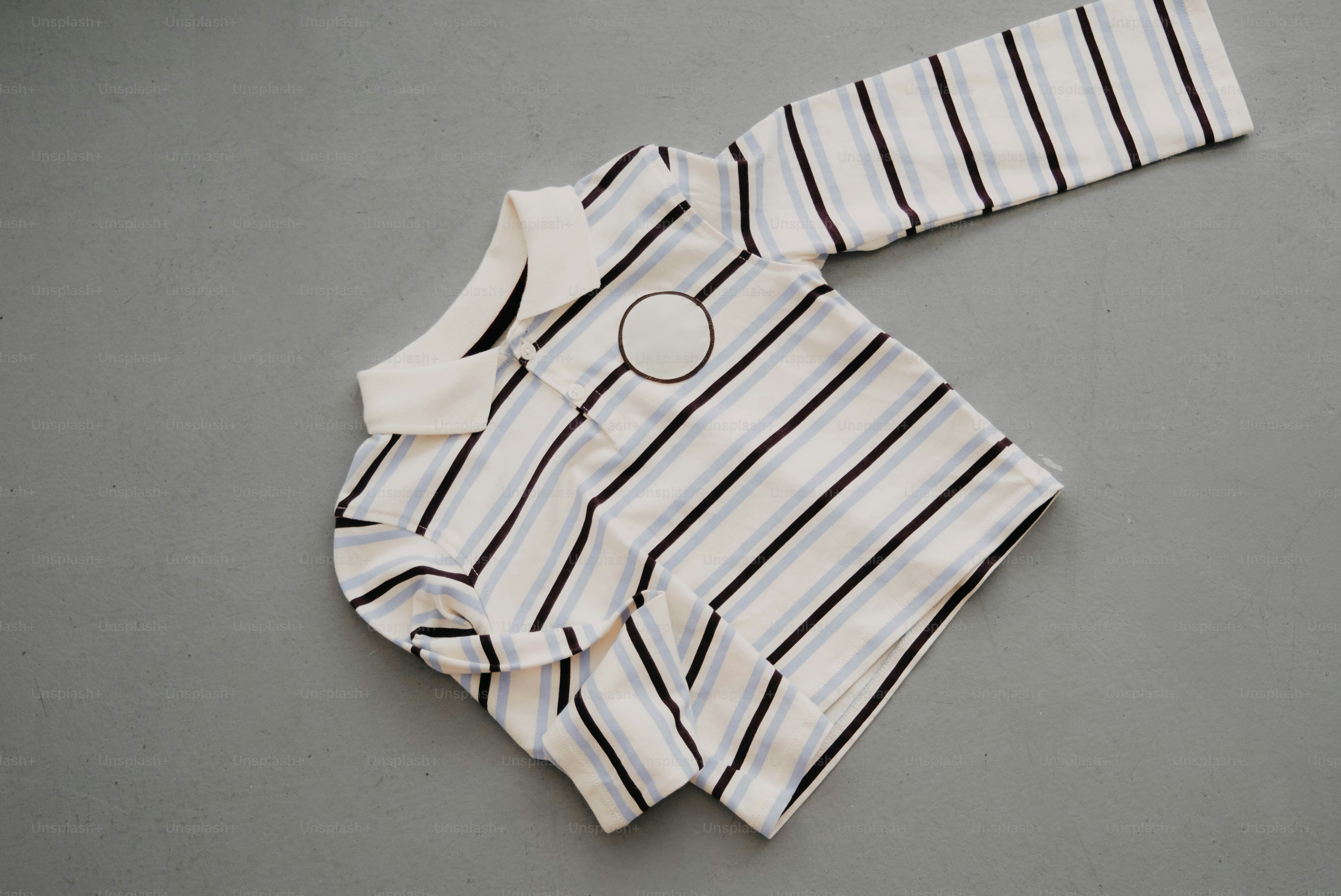 Striped long-sleeved shirt with a circular emblem