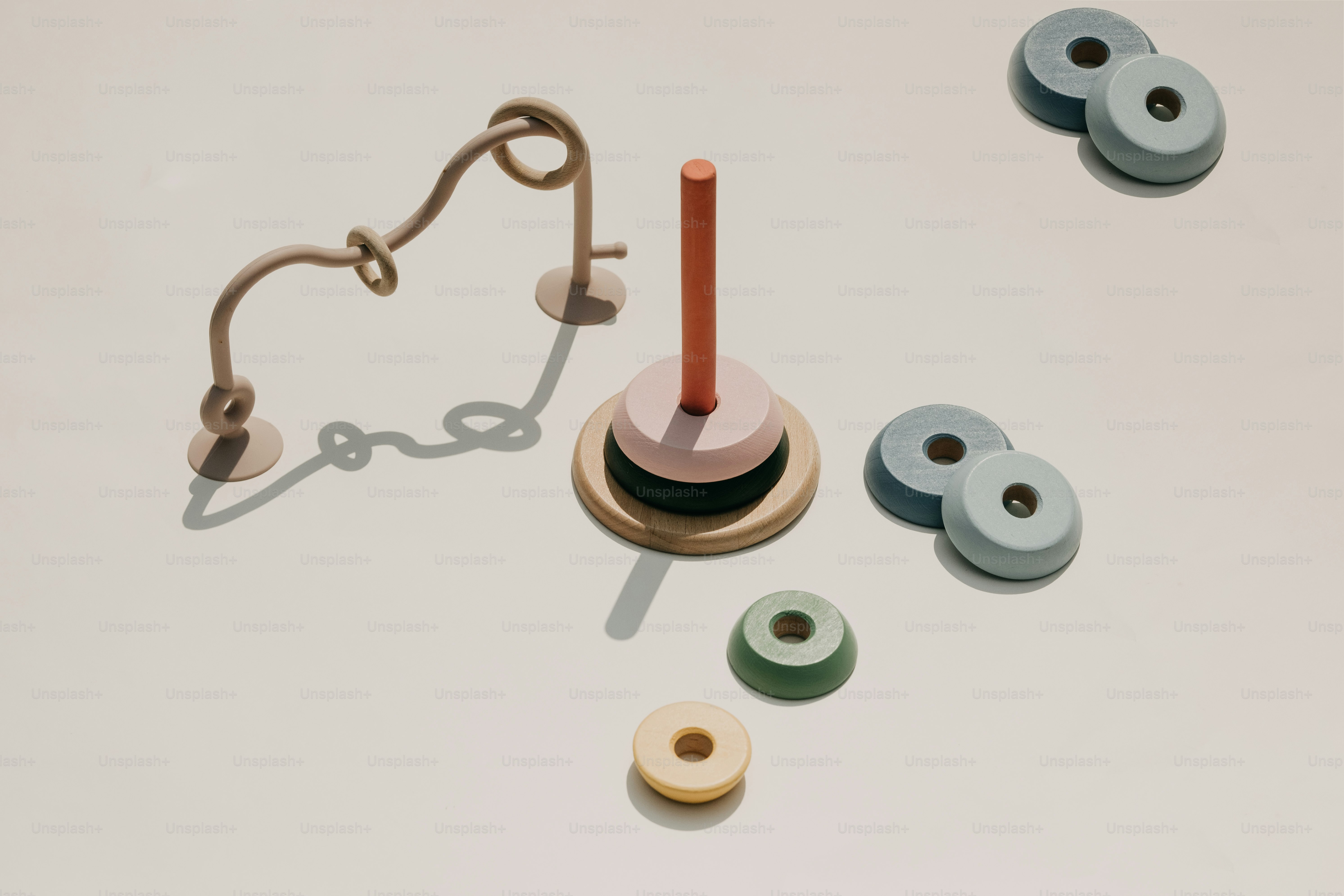 Wooden stacking toy with pastel colored rings