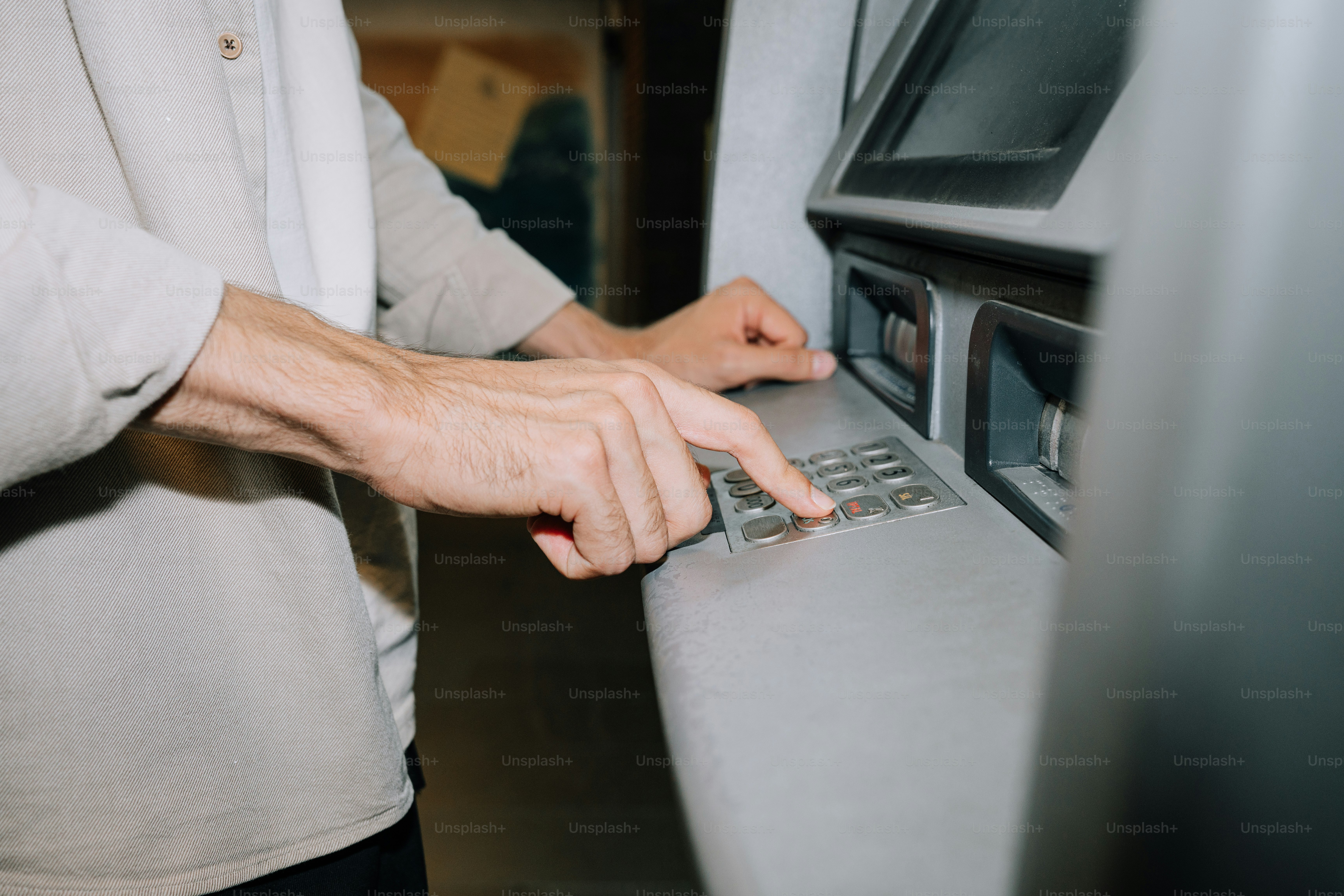Hand inserting blue card into atm machine. photo – Money Image on Unsplash
