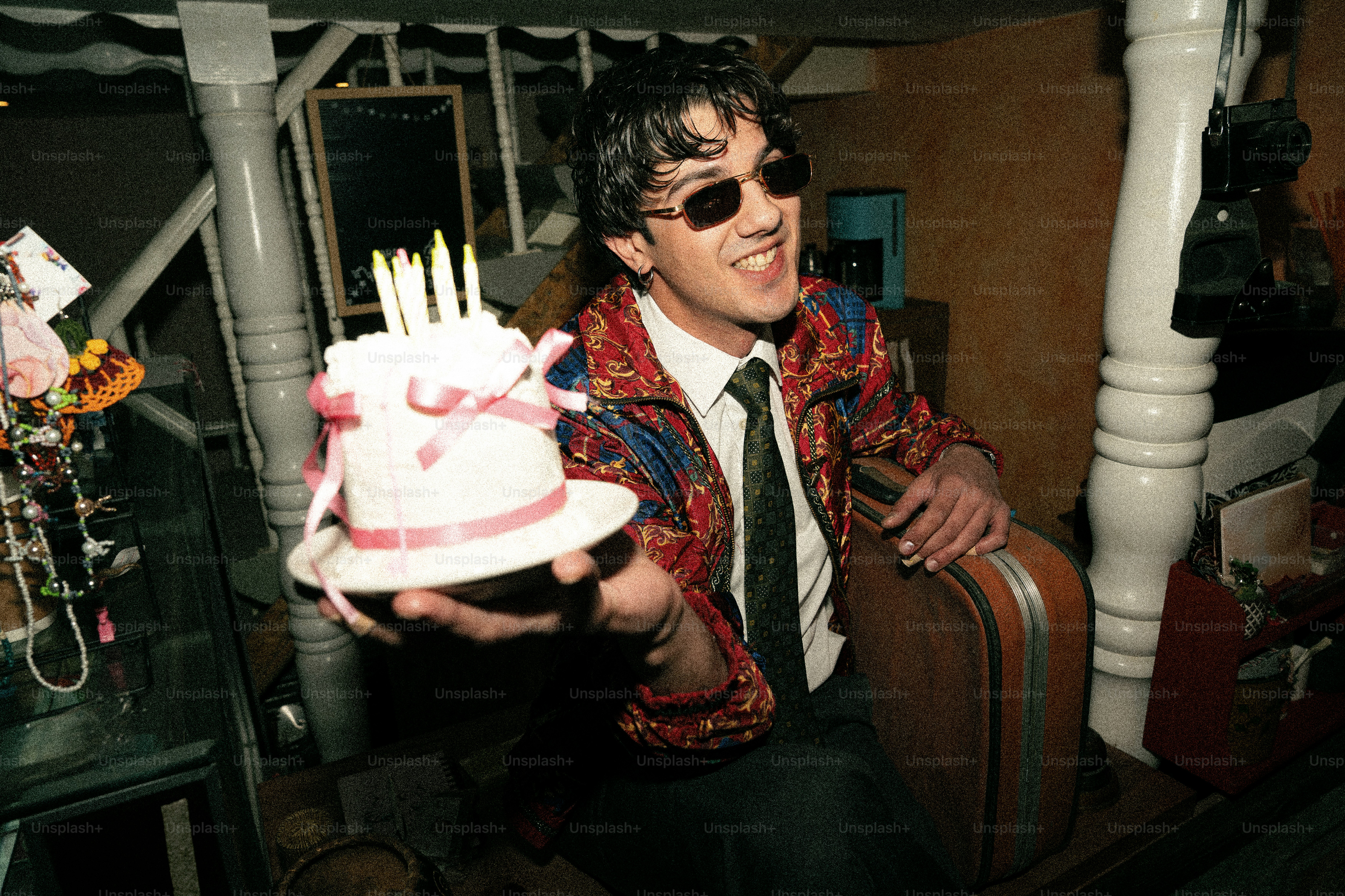 Man in sunglasses holding a birthday cake