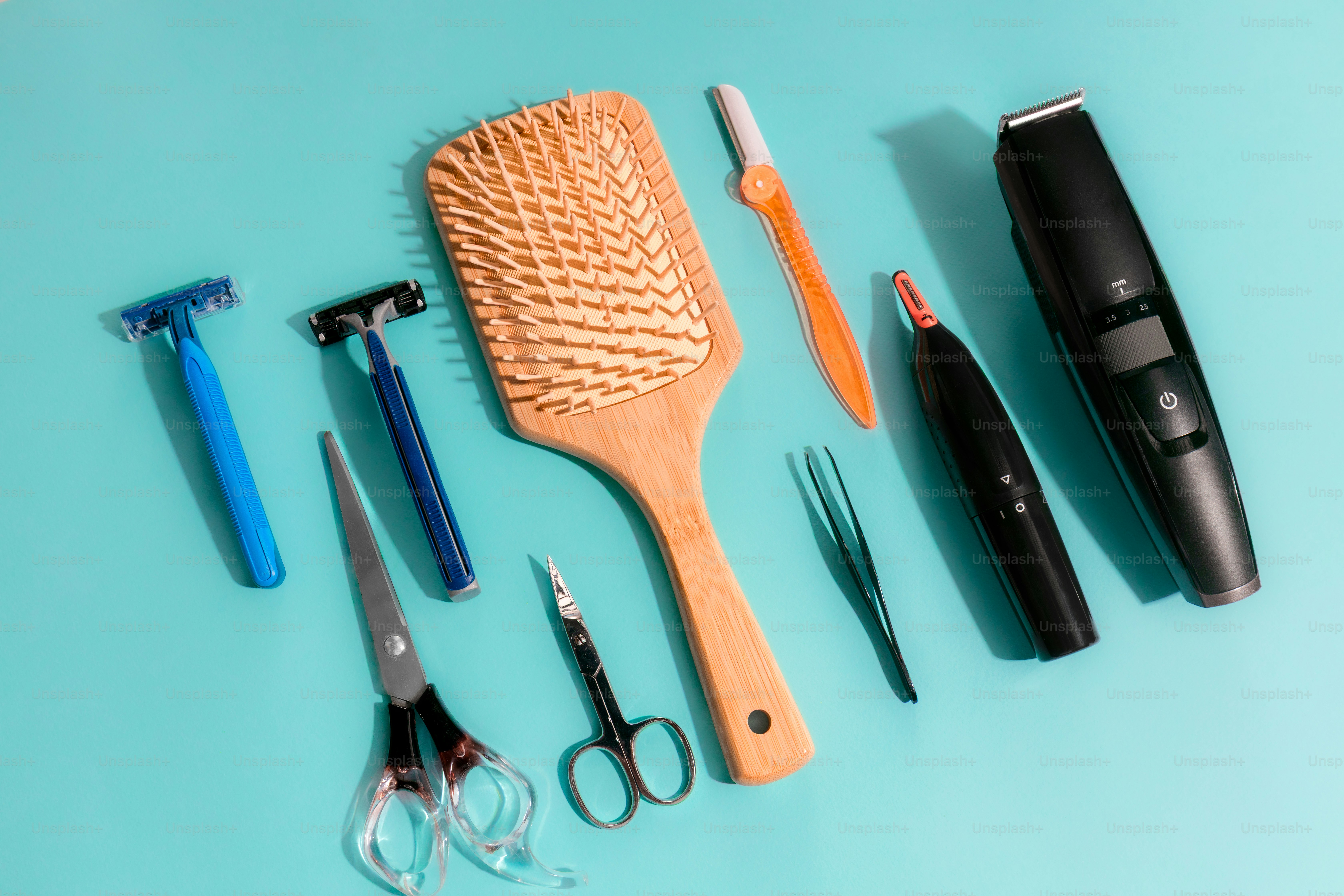 Grooming tools arranged on a light blue background.