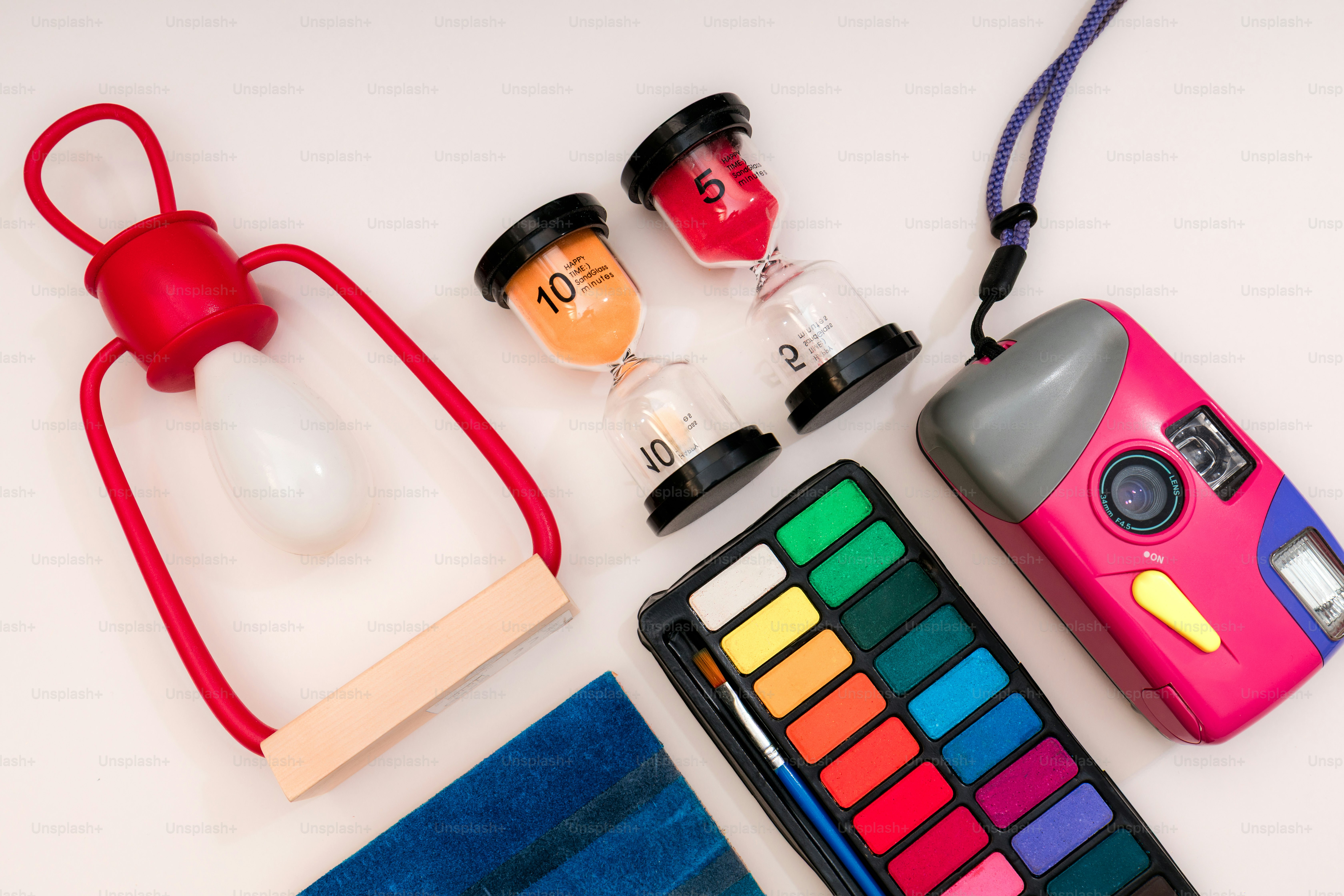 Art supplies and vintage camera arranged on a white surface