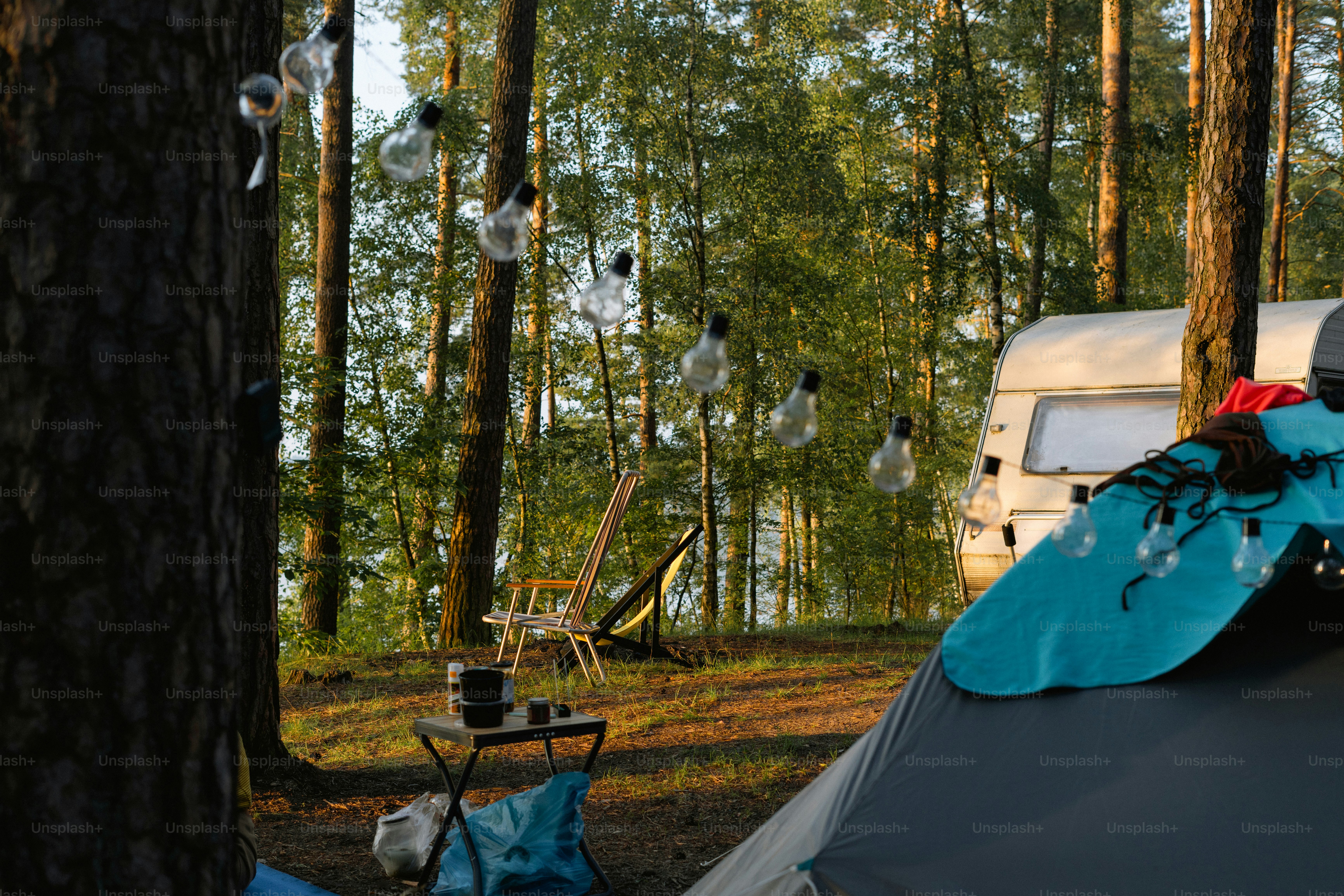 Camping scene with tent, caravan, and forest background photo – Forest ...
