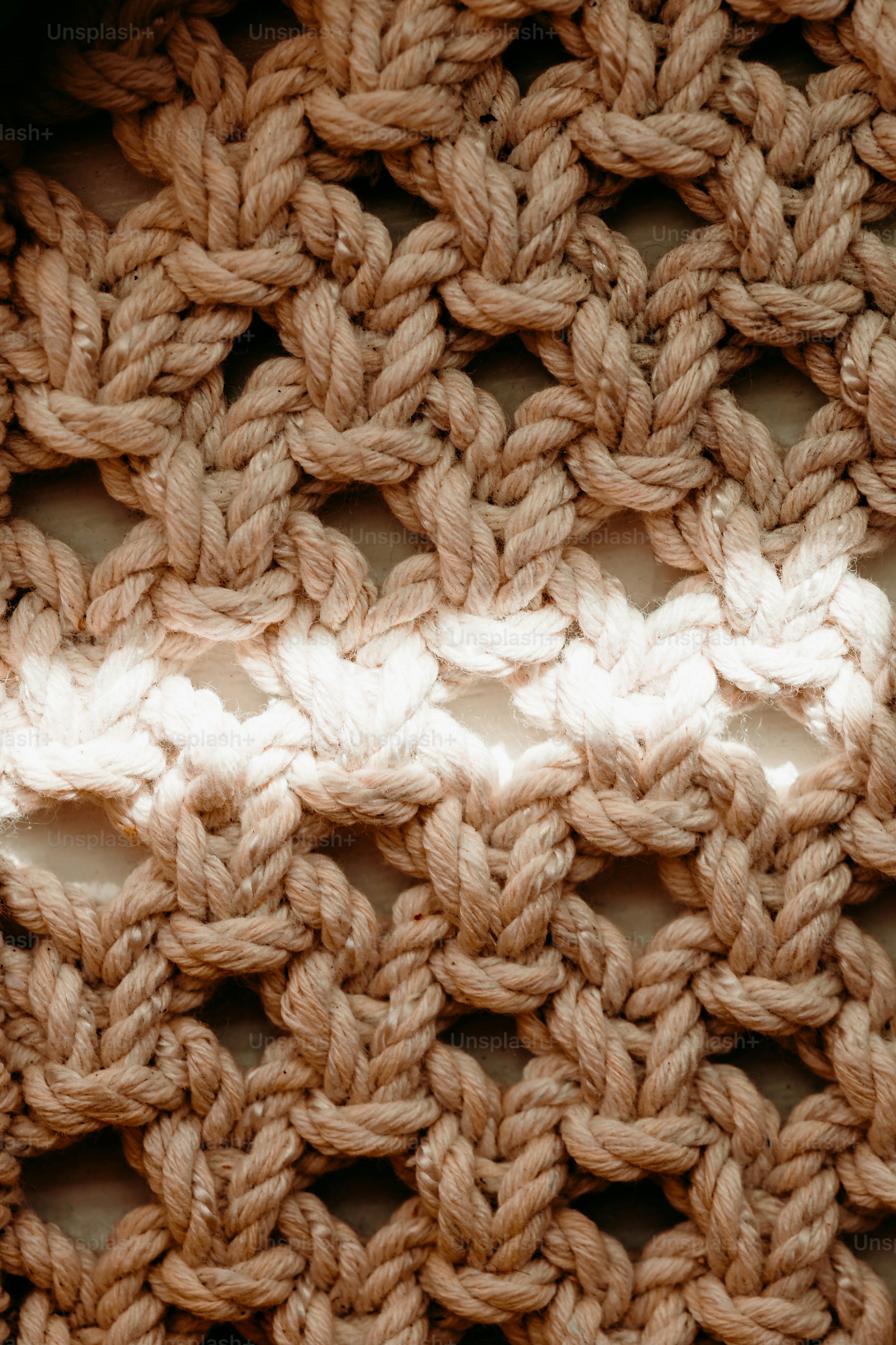 Close-up of a woven macrame pattern with light