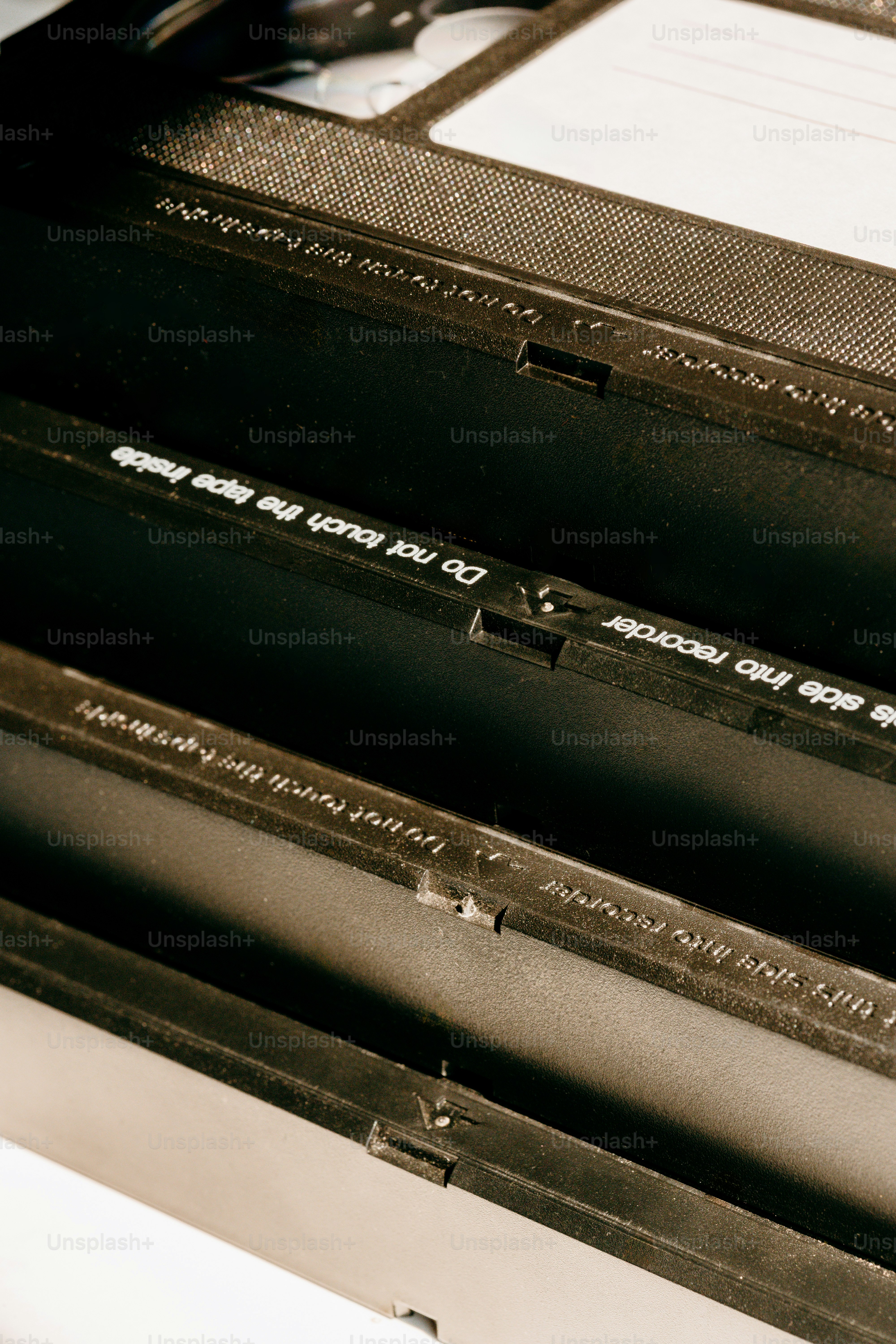 Stack of vintage vhs tapes with warning labels.