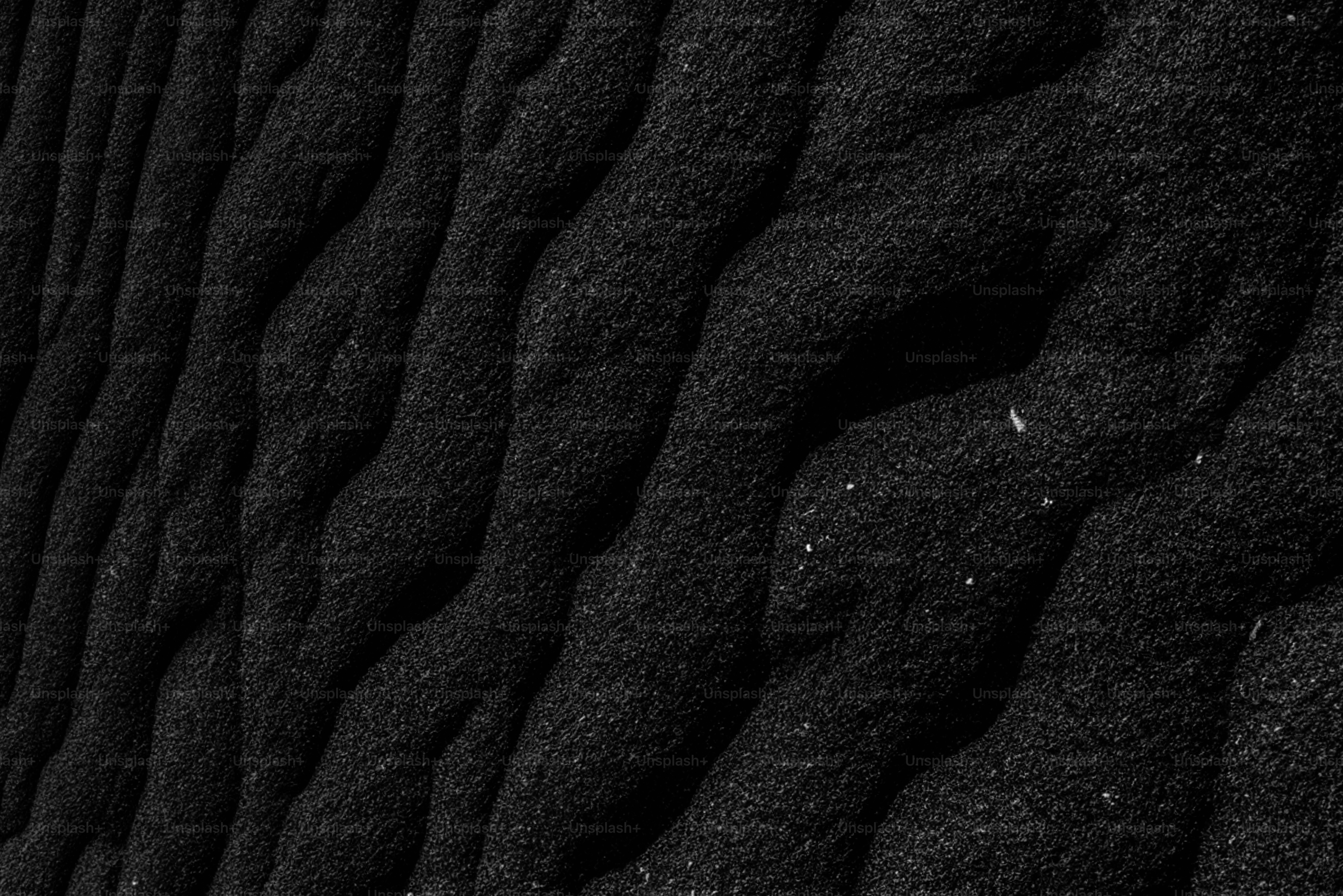 Textured black surface with undulating patterns