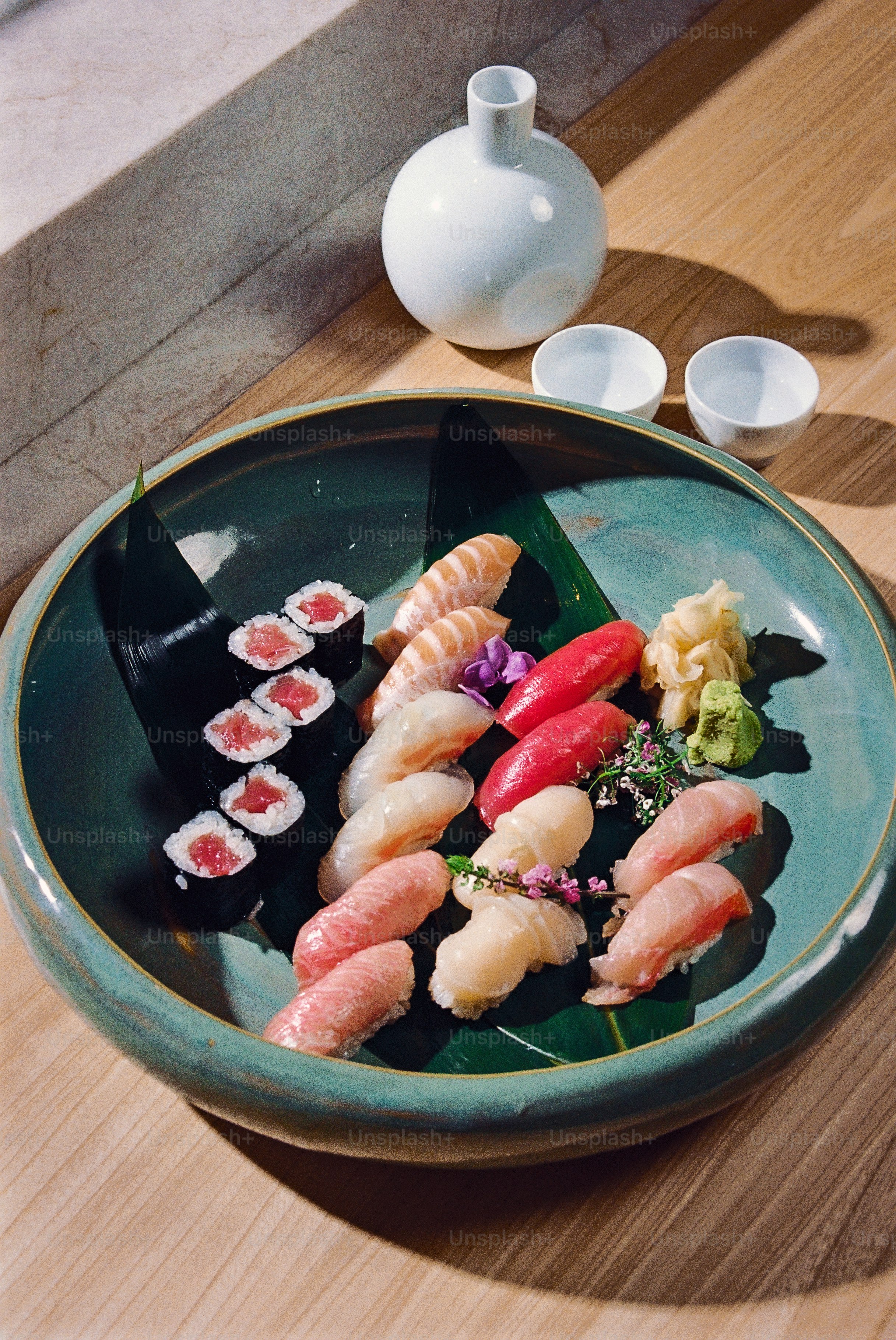 Assortment of sushi and sashimi served on a platter.