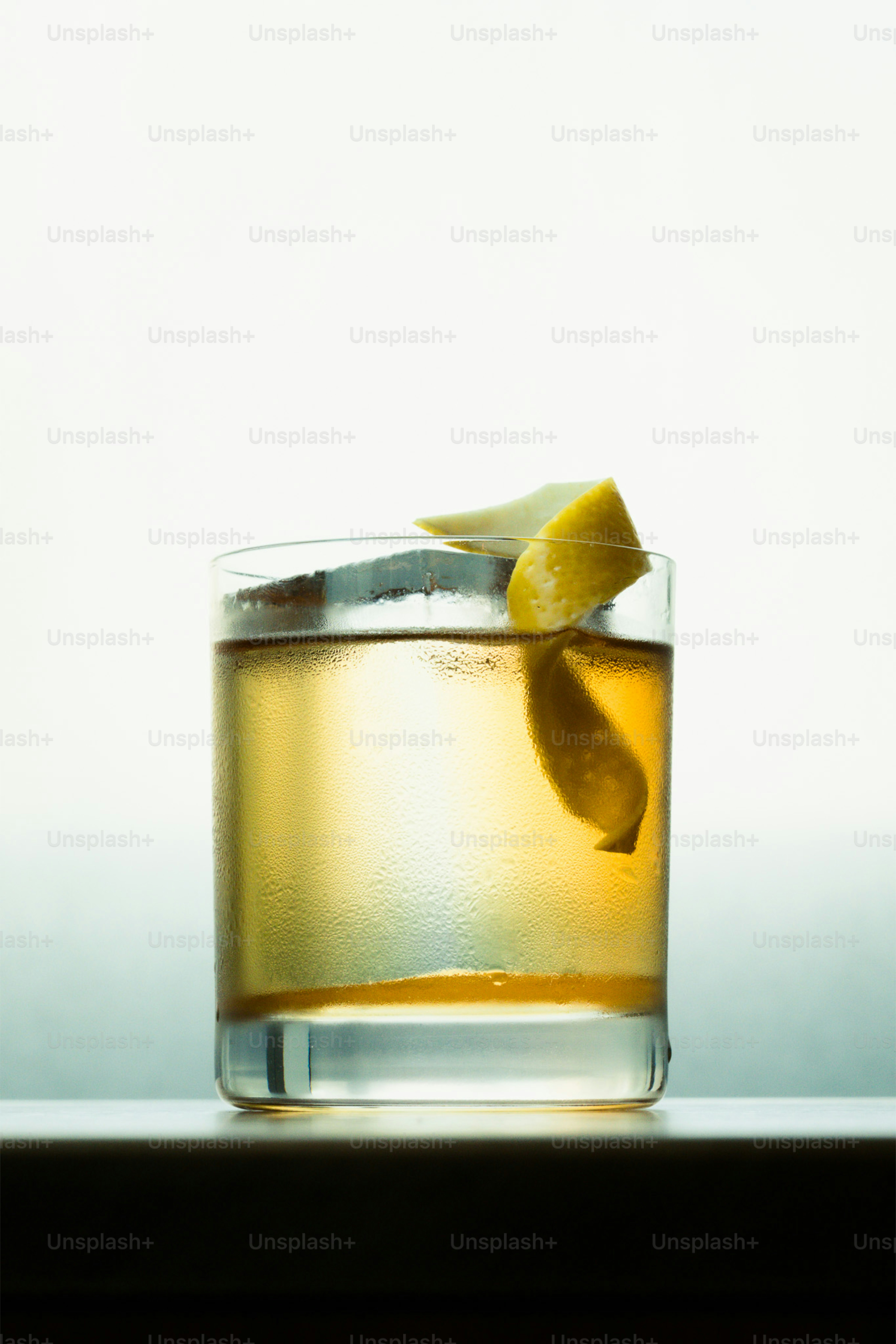 A refreshing cocktail with lemon peel garnish