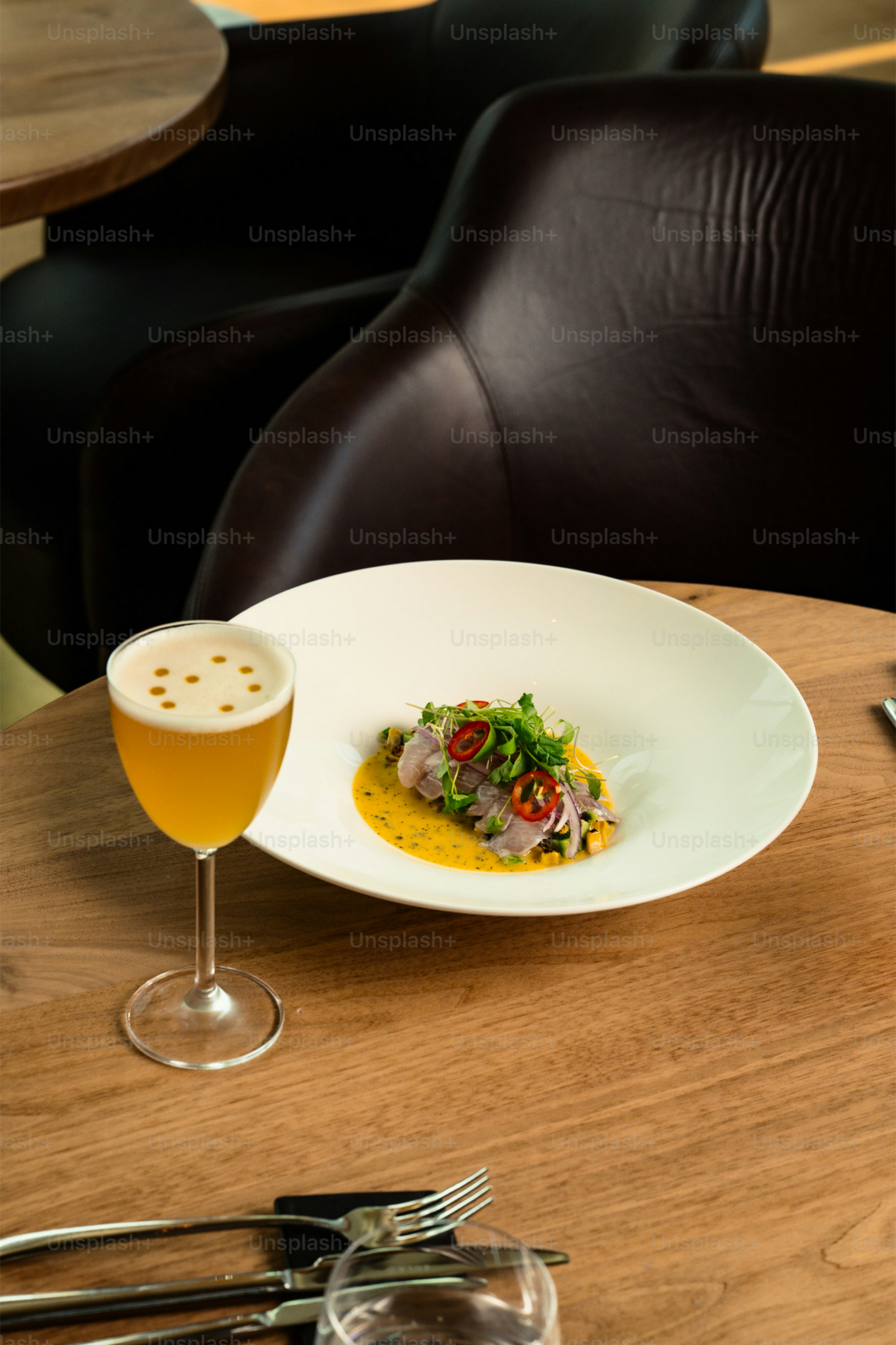 Gourmet ceviche with a beer on a wooden table