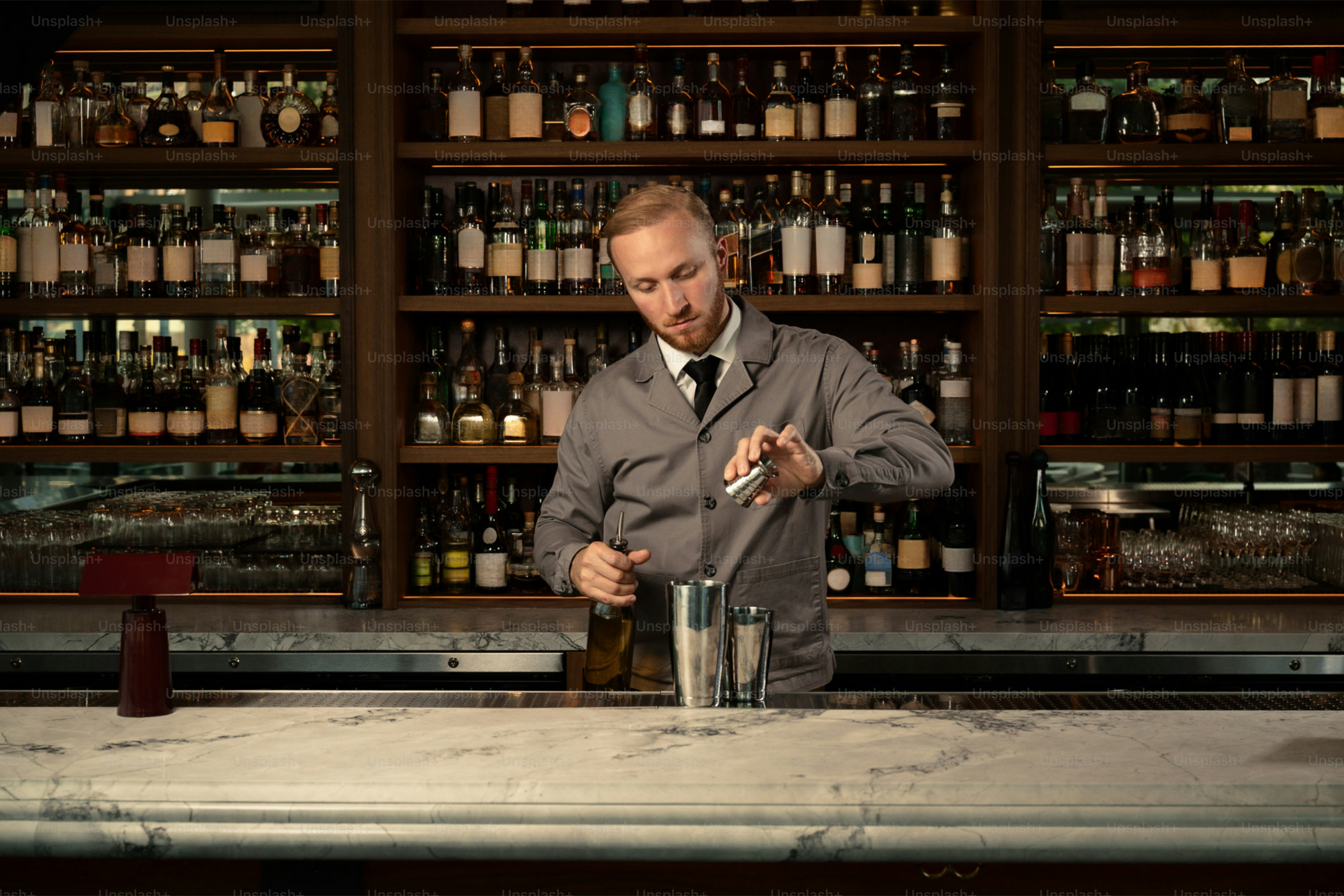 Bartender garnishing a cocktail behind a bar photo – Bar Image on Unsplash