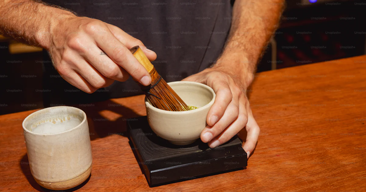 Hands whisking matcha tea in a bowl photo – Coffee Image on Unsplash