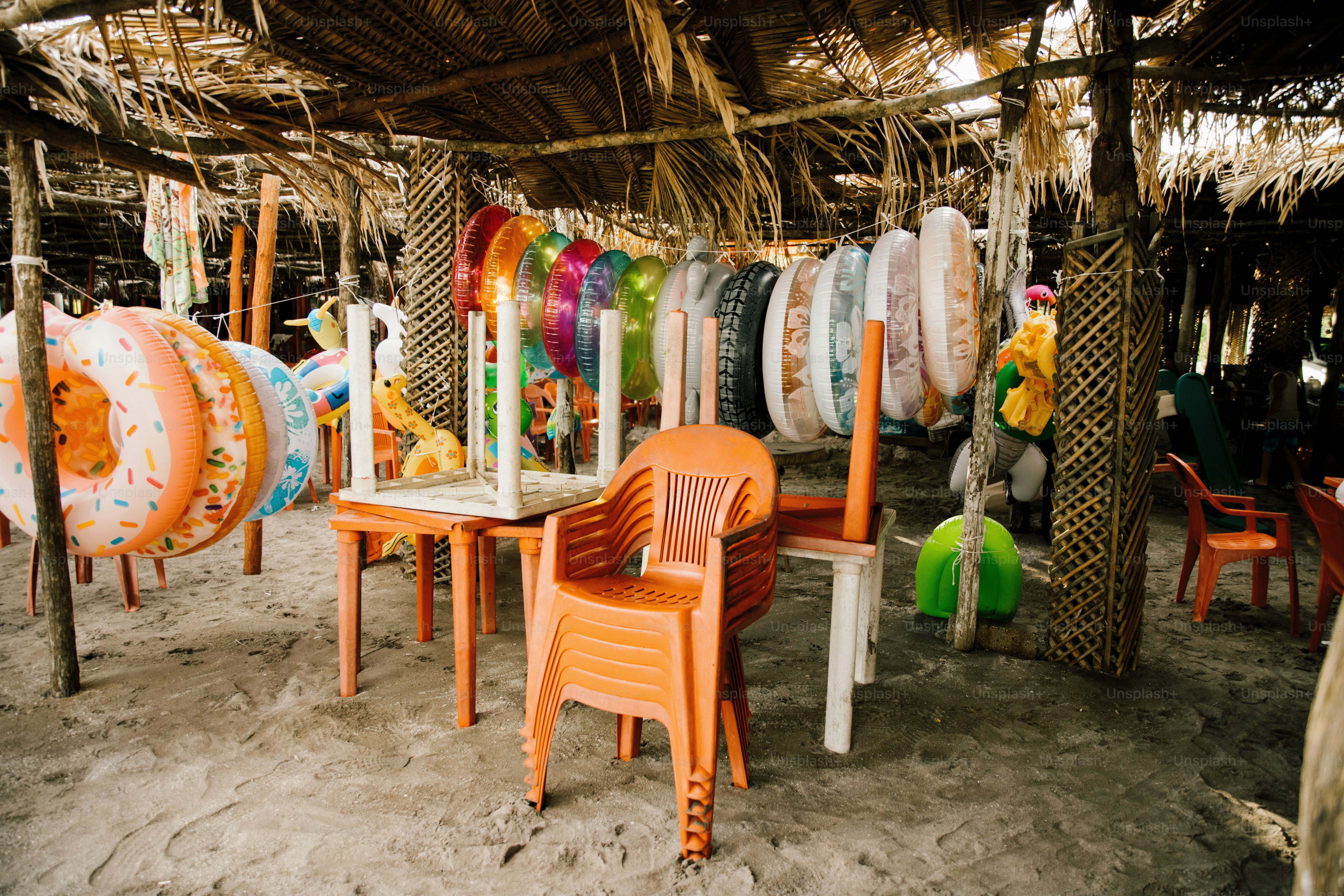 Beachside stall with inflatable rings and chairs