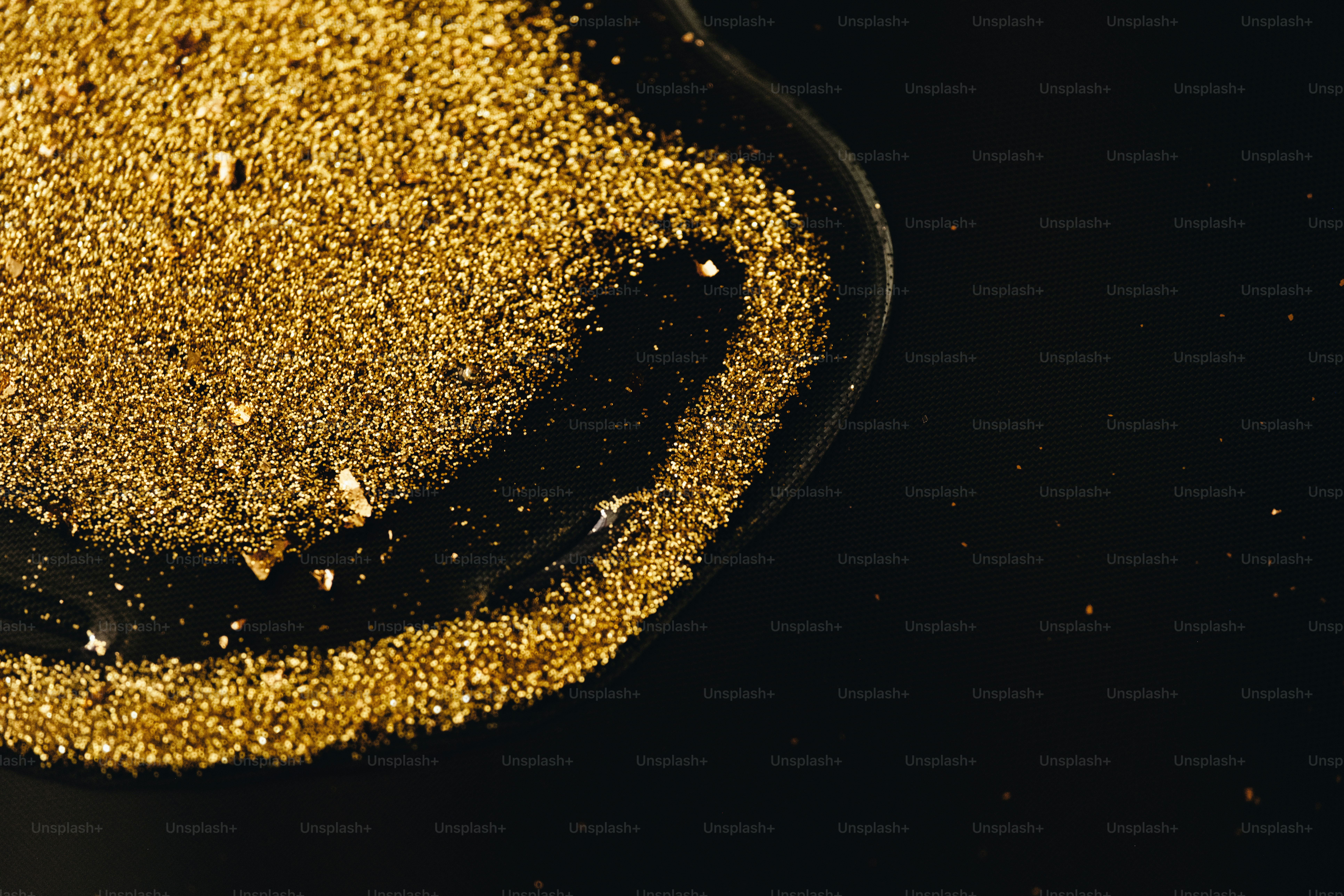 Pile of gold dust on a dark surface