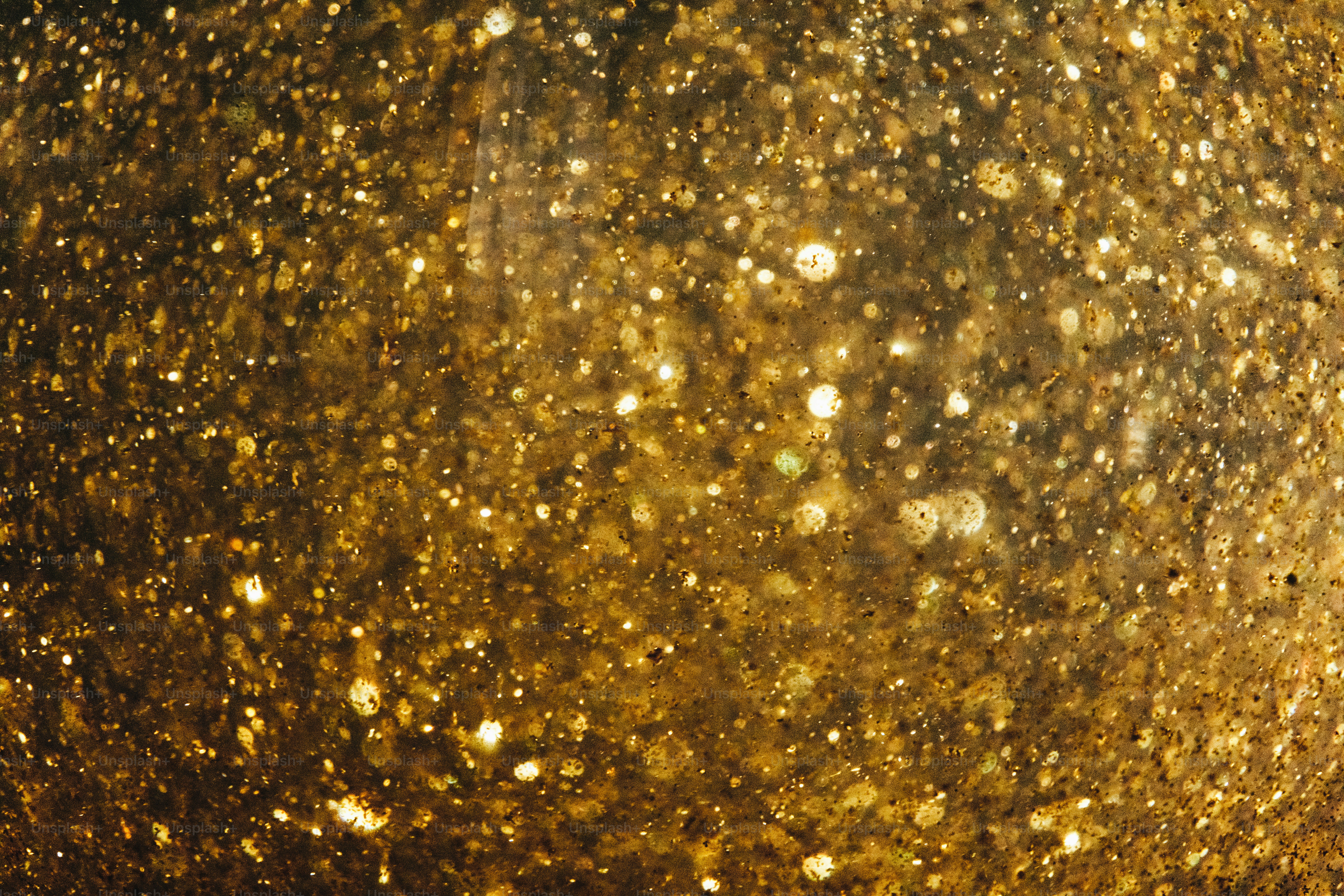 Abstract golden glitter texture with bokeh effect
