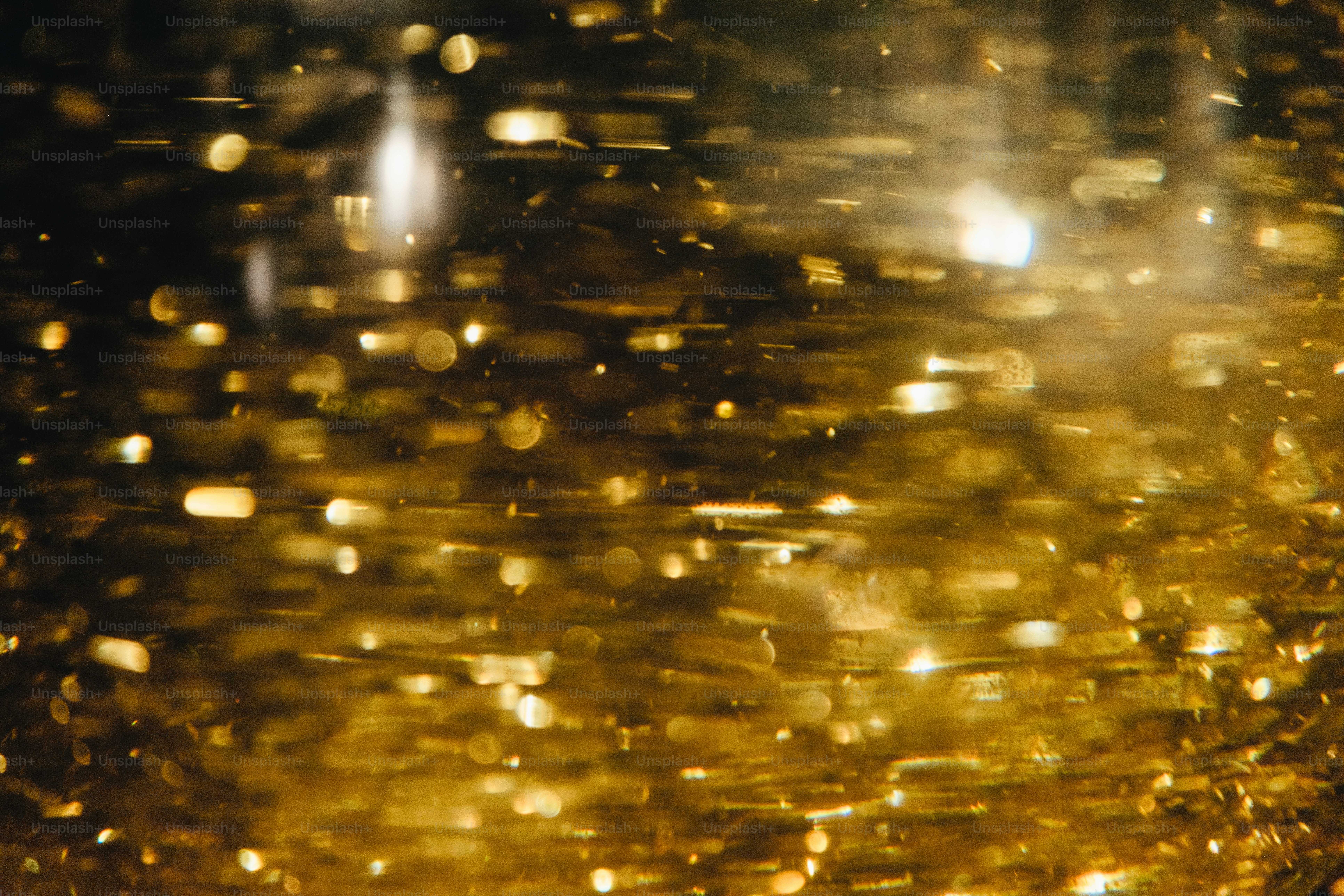 Abstract golden particles shimmering in liquid