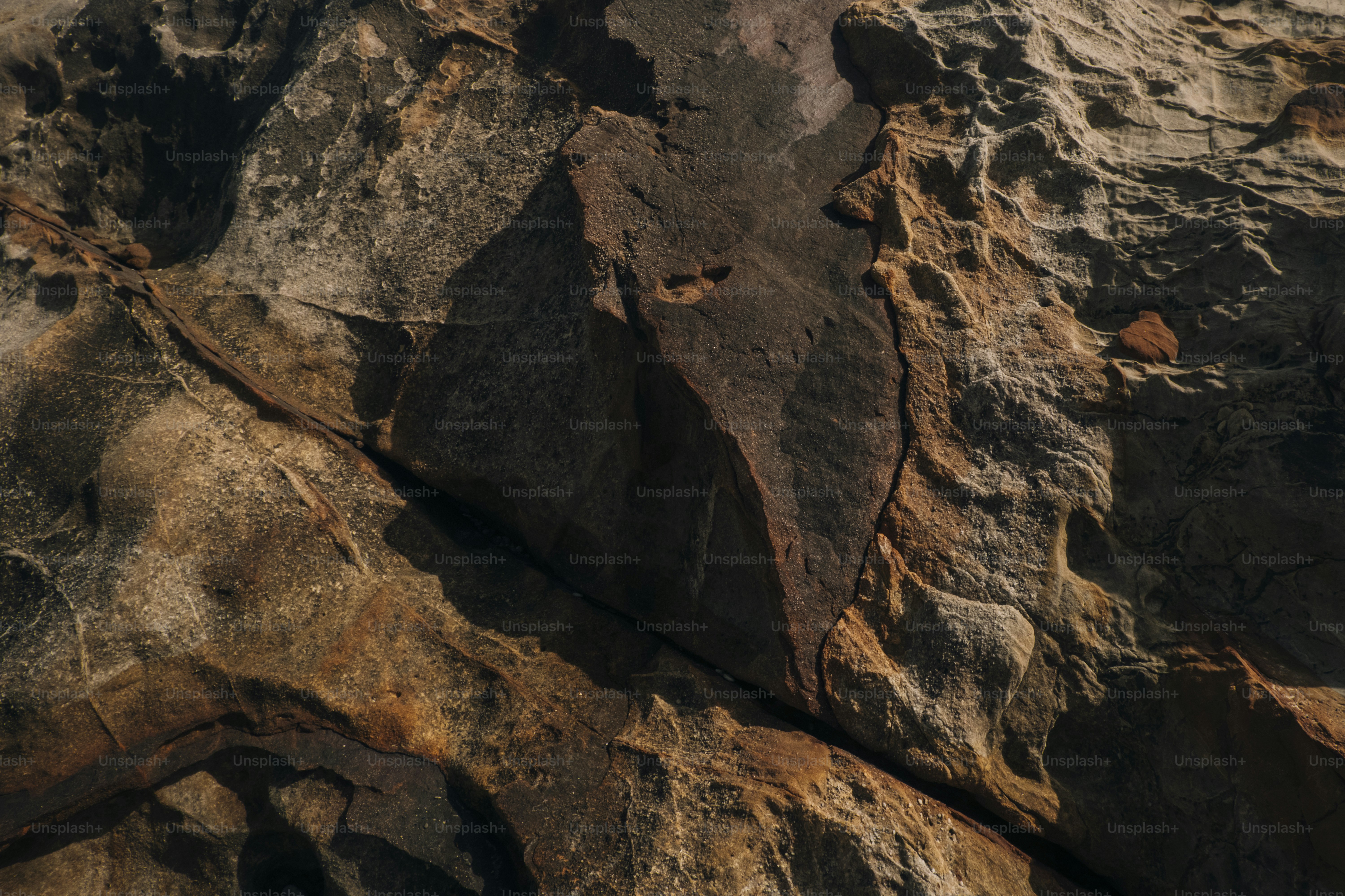 Close-up texture of weathered rock with deep cracks